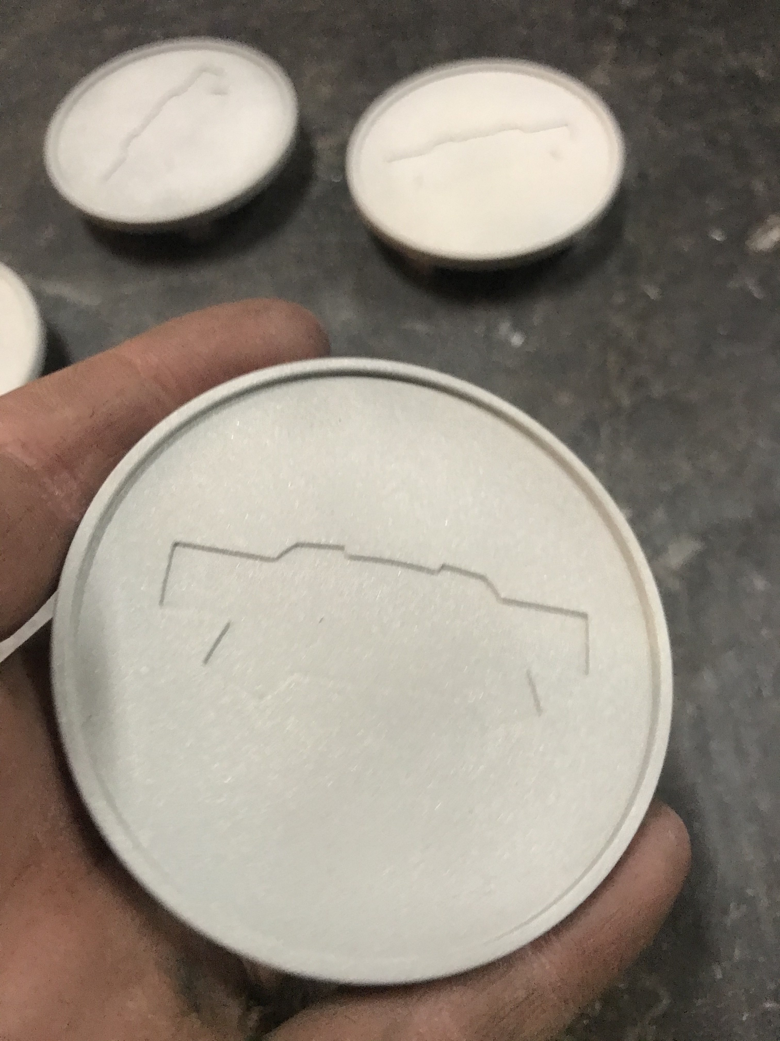 Custom machined caps embossed with a subtle bowtie silhouette — one of the small in-house details tucked into the finished truck.