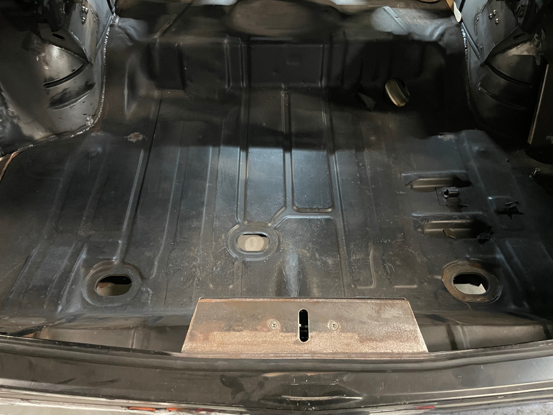 Rear floor pan and widened wheel tubs installed — the shell is rock-solid.