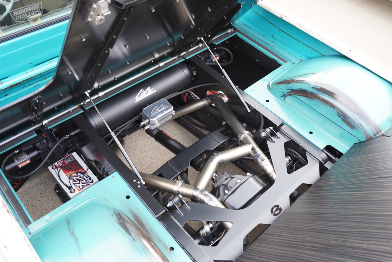 Bed floor lifted — finished rear structure, air system, and chassis details underneath.