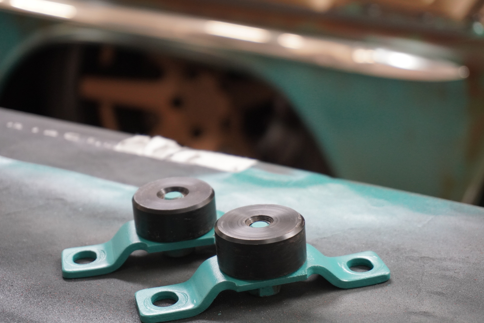 Delrin bed-mount bushings tuned in length and diameter to tighten up tailgate operation, eliminating squeaks and side-to-side slop while keeping panel gaps tight and protecting the patina paint from chipping.