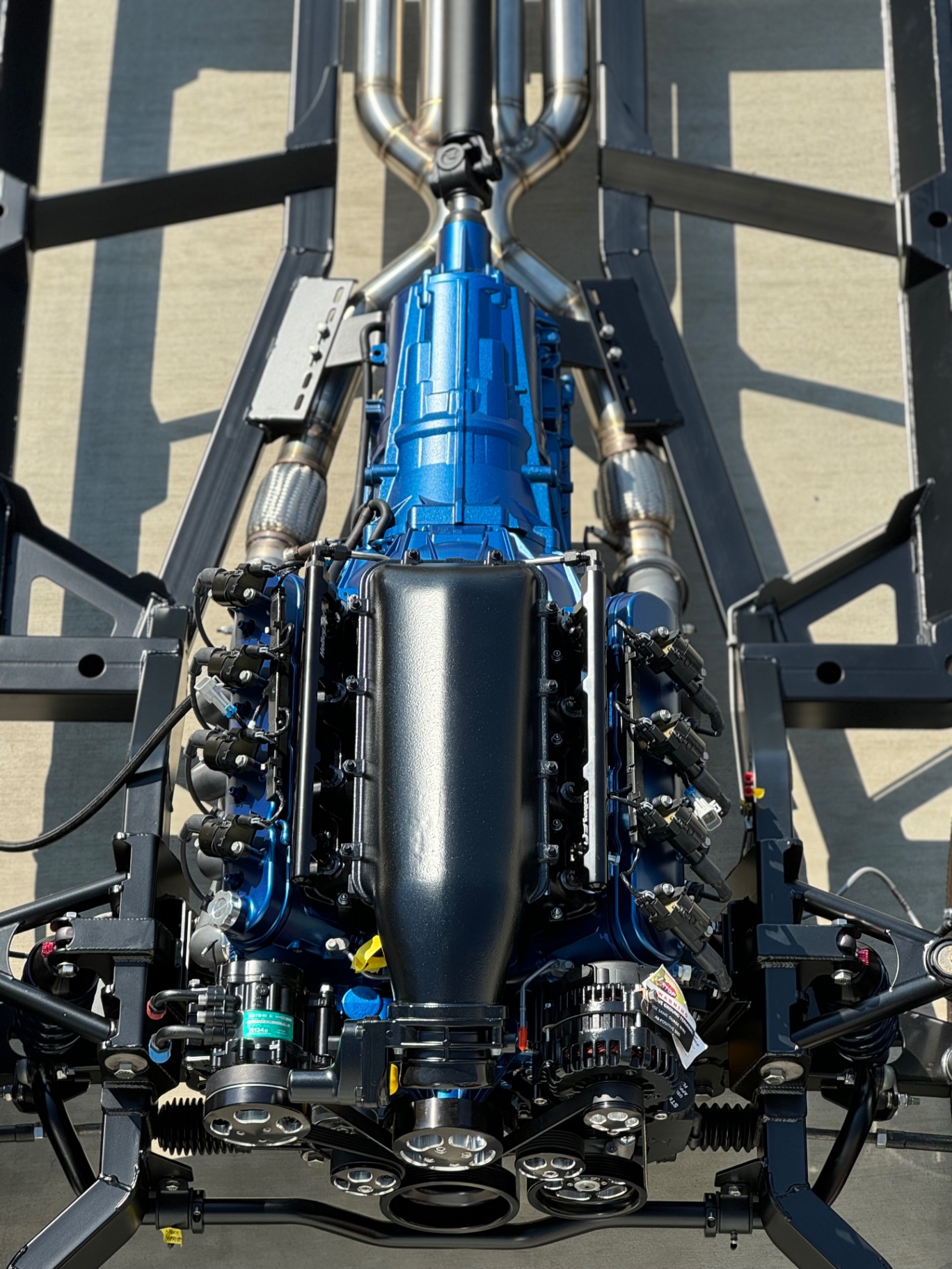 Overhead — LS3 and 6-speed auto mocked into the SPEC chassis with stainless exhaust.