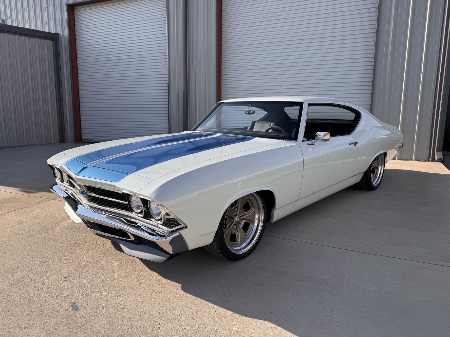 Driver-side front three-quarter — finished paint and stripes.