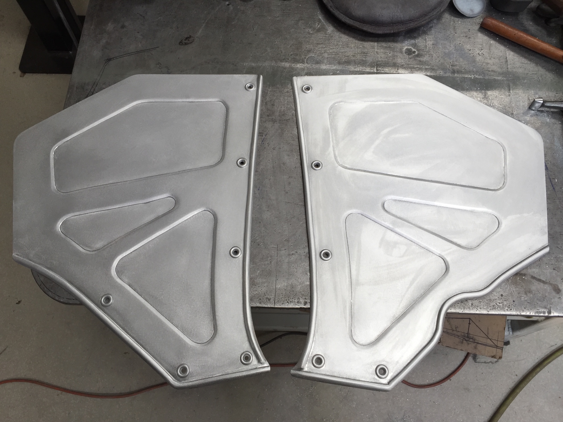 Both halves off the buck before final trim — mirrored recesses for a symmetrical look.