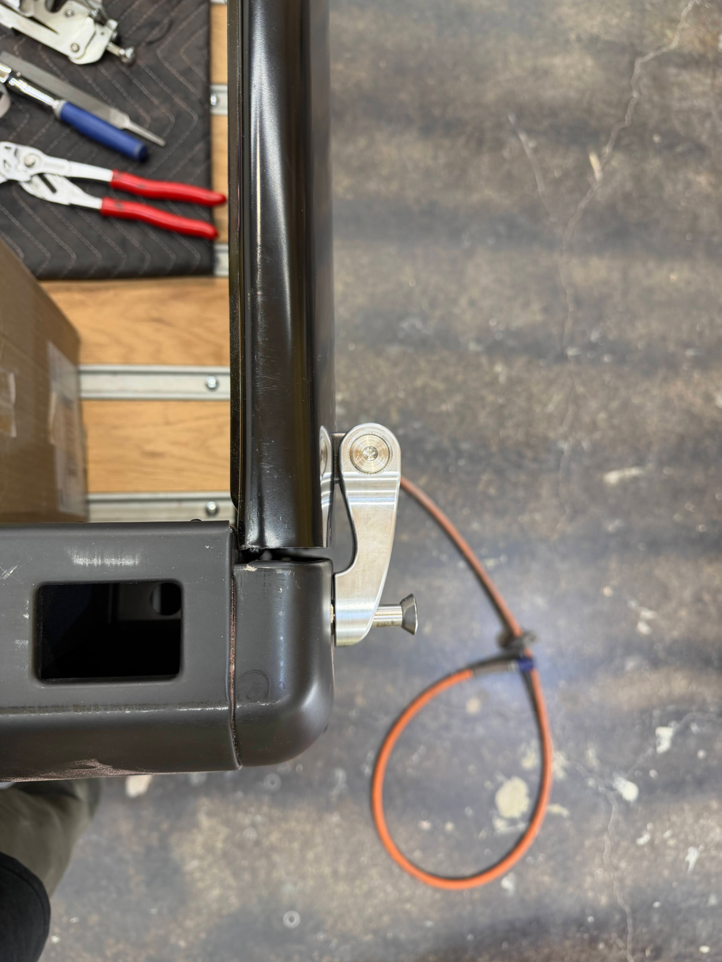 Billet latch and stop mounted at the bedside — clean, positive engagement.