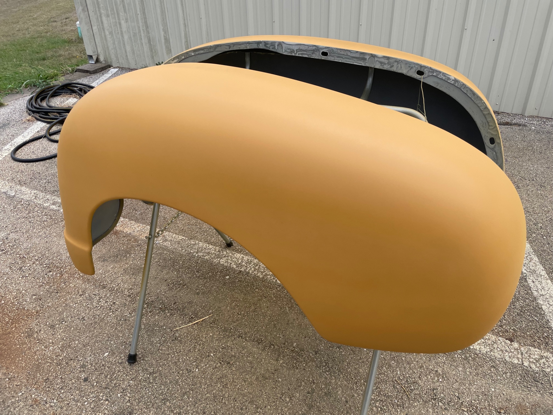 Rear fender in orange high-build — surface reads clean under raking light.