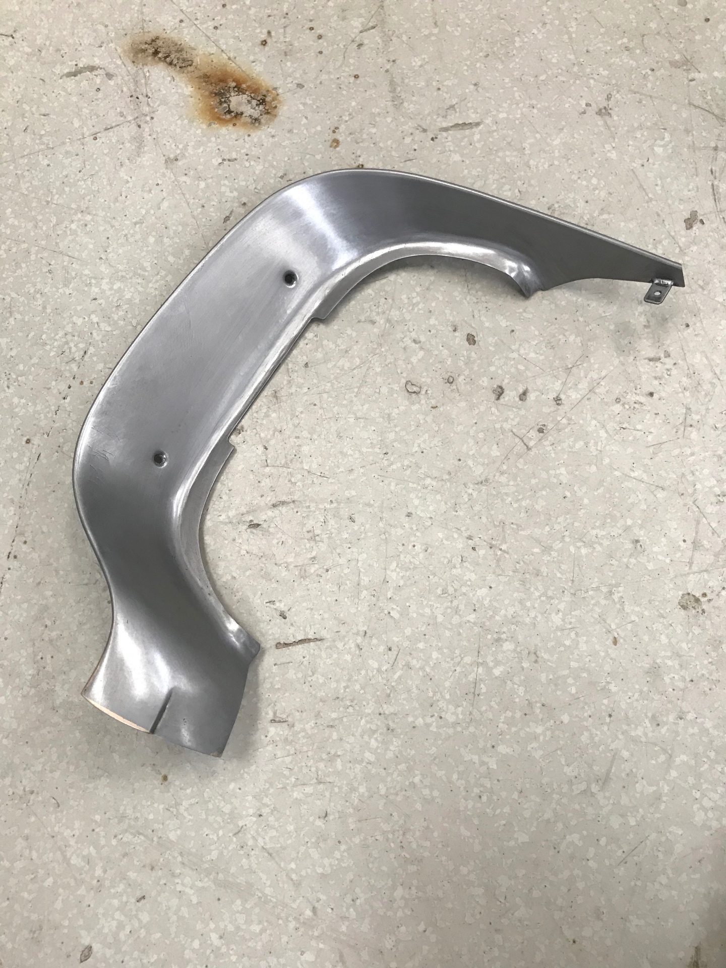 Raw bezel off the wheel — 14ga steel, hand-formed to the original profile.