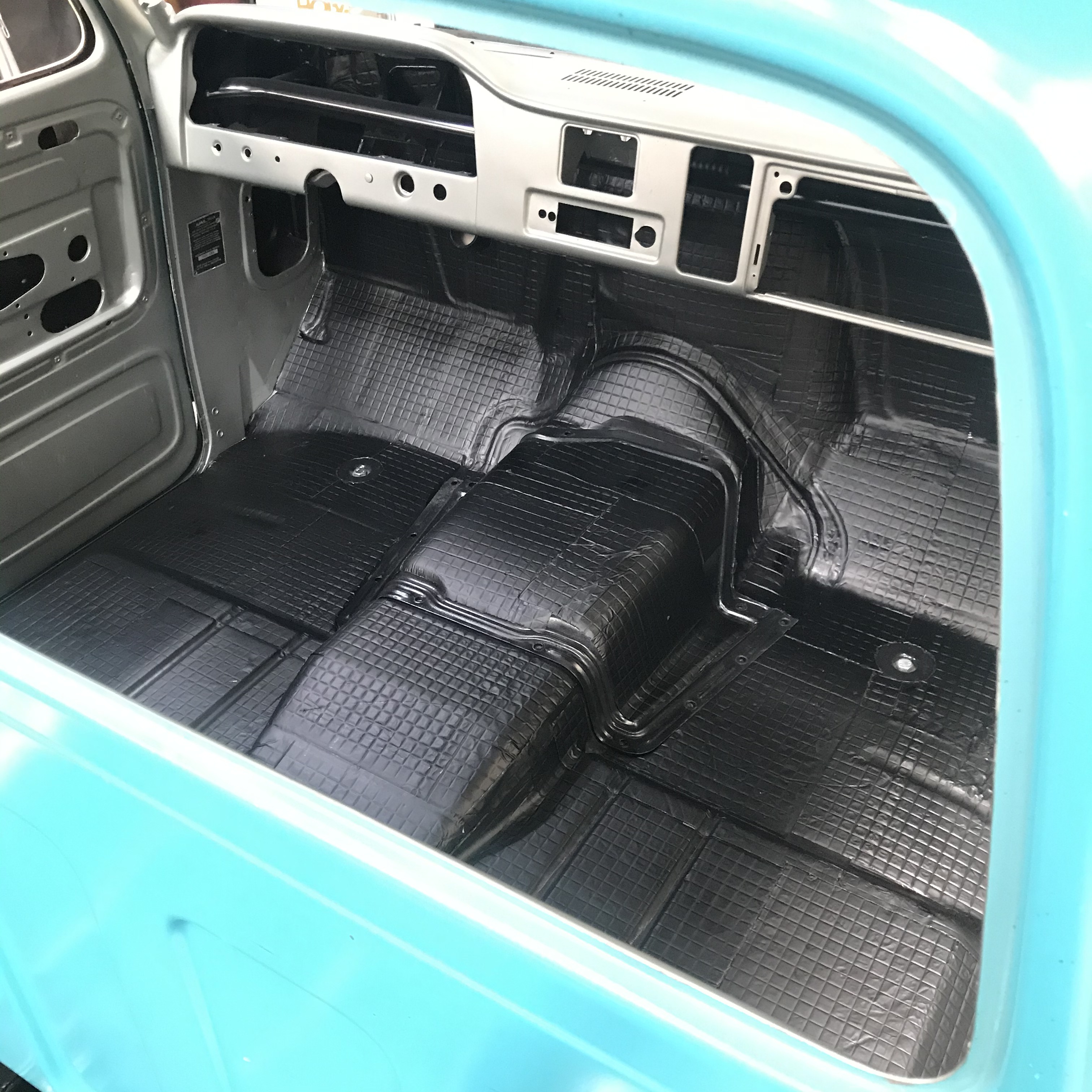 Cab-in-progress view showing the metalwork and floor before final trim.