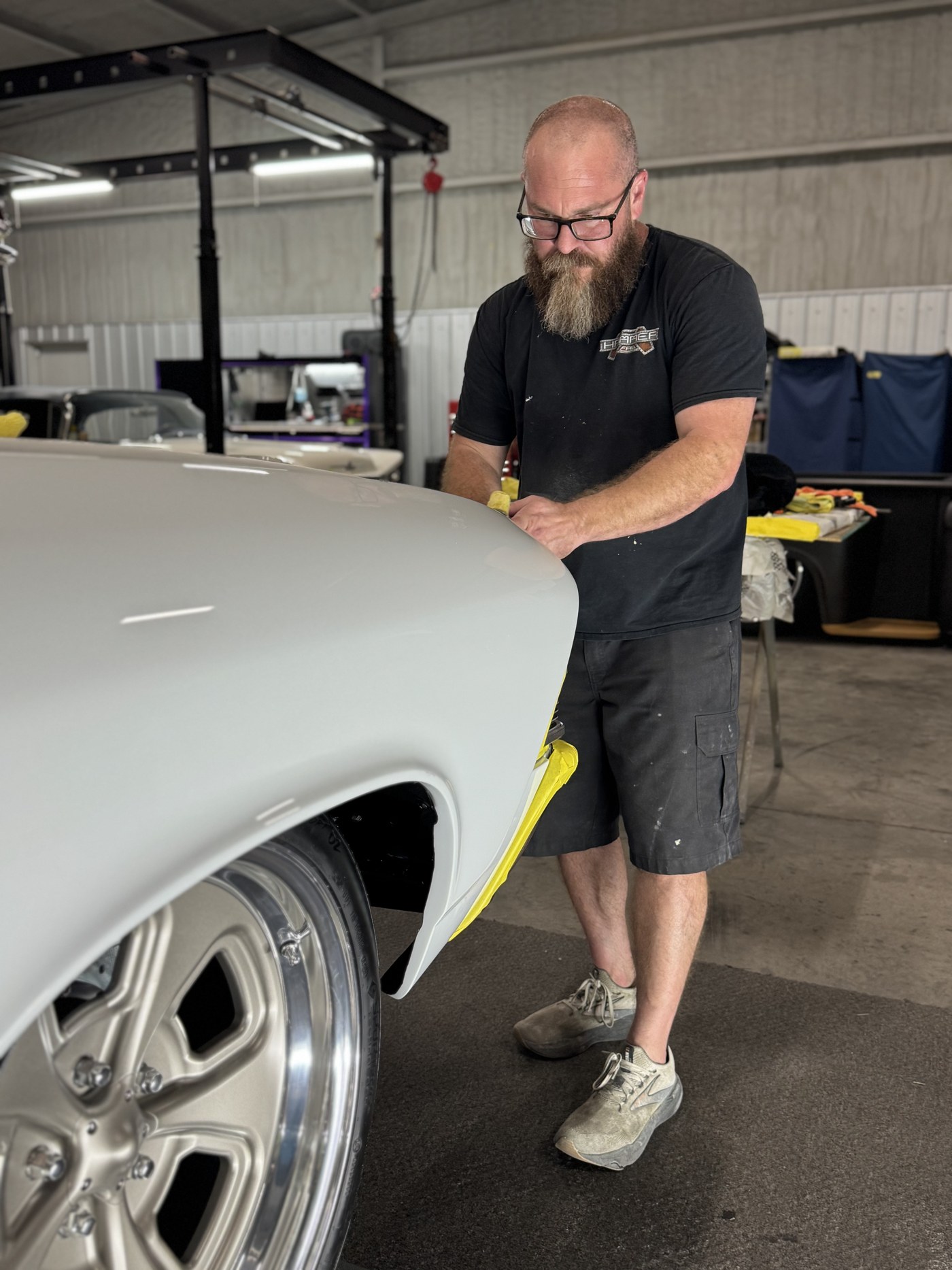 Hammer Fab craftsman block-sanding a hand-built fender