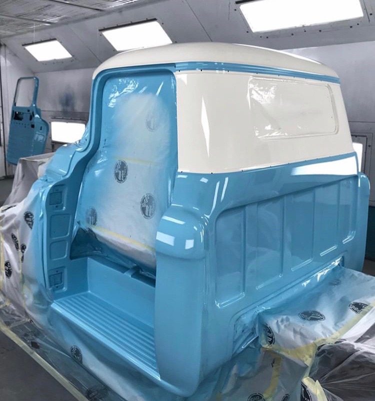 Fresh two-tone paint out of the booth — period Chevy blue over white.