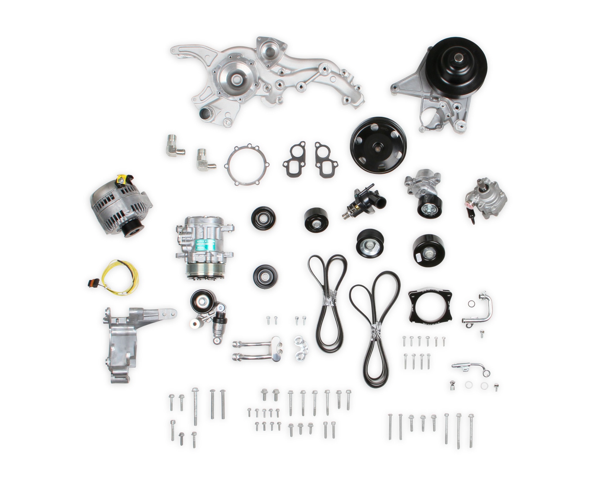 The Holley mid-mount kit as it arrives — brackets, alternator, A/C compressor, power steering pump, tensioners, pulleys, belts, and hardware.