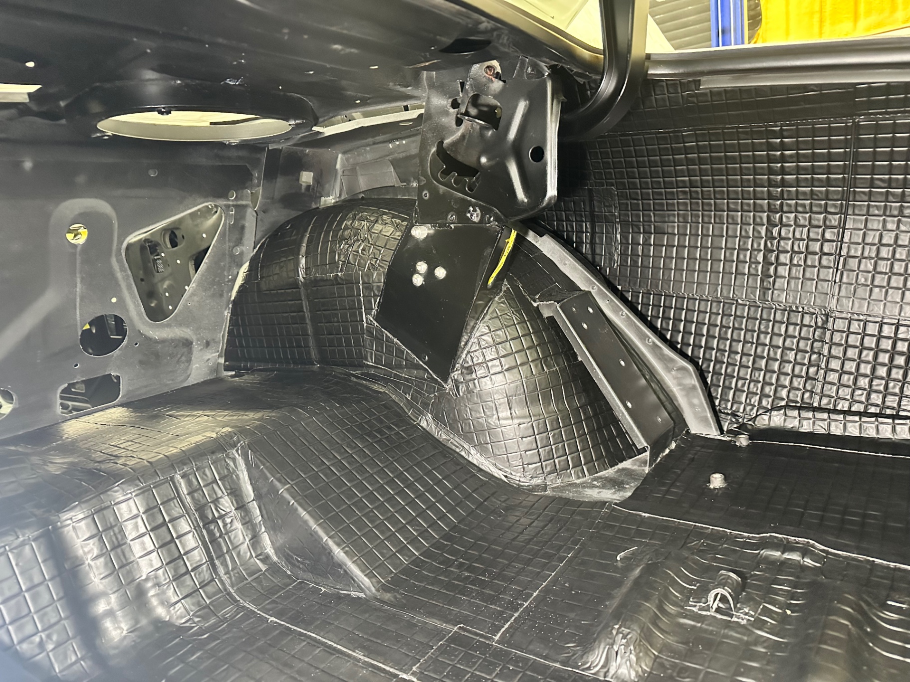 Trunk interior sealed and sound-deadened — every inner surface finished to match.