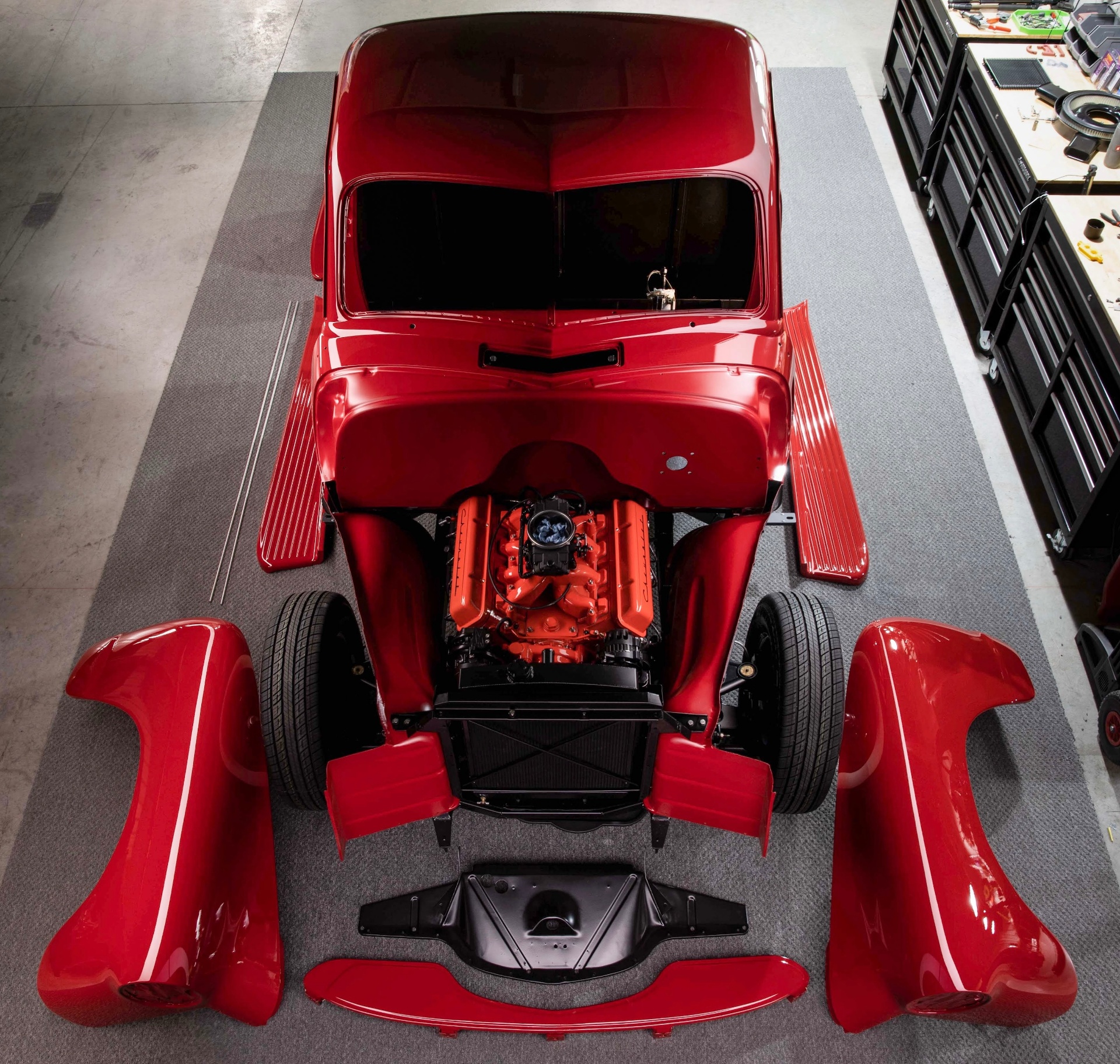 Overhead of the cab on the chassis with fenders, hood sides, and running boards staged around it — Don Hardy 4.8L LS sitting between the frame rails.