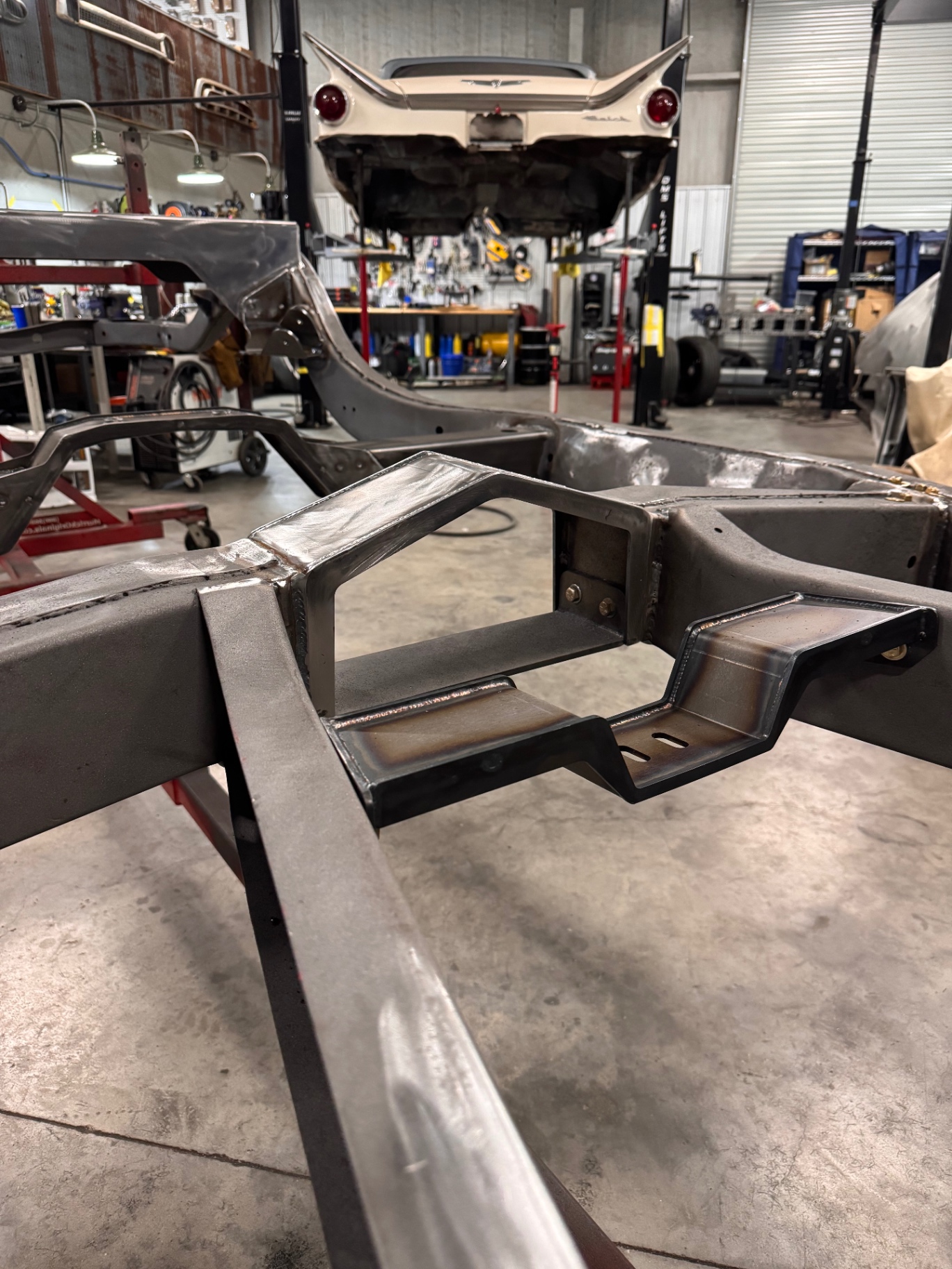 Bolt-in transmission crossmember and driveshaft loop in place