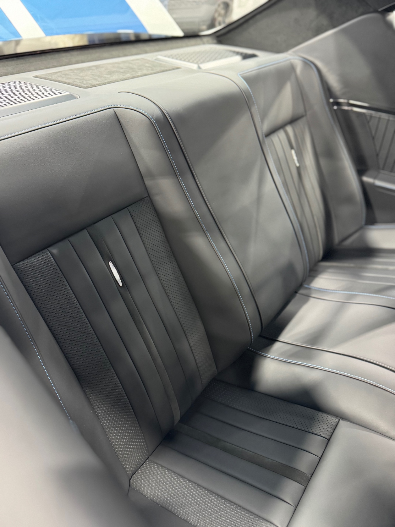 Rear seat detail — matching pleats and perforation under the package tray.