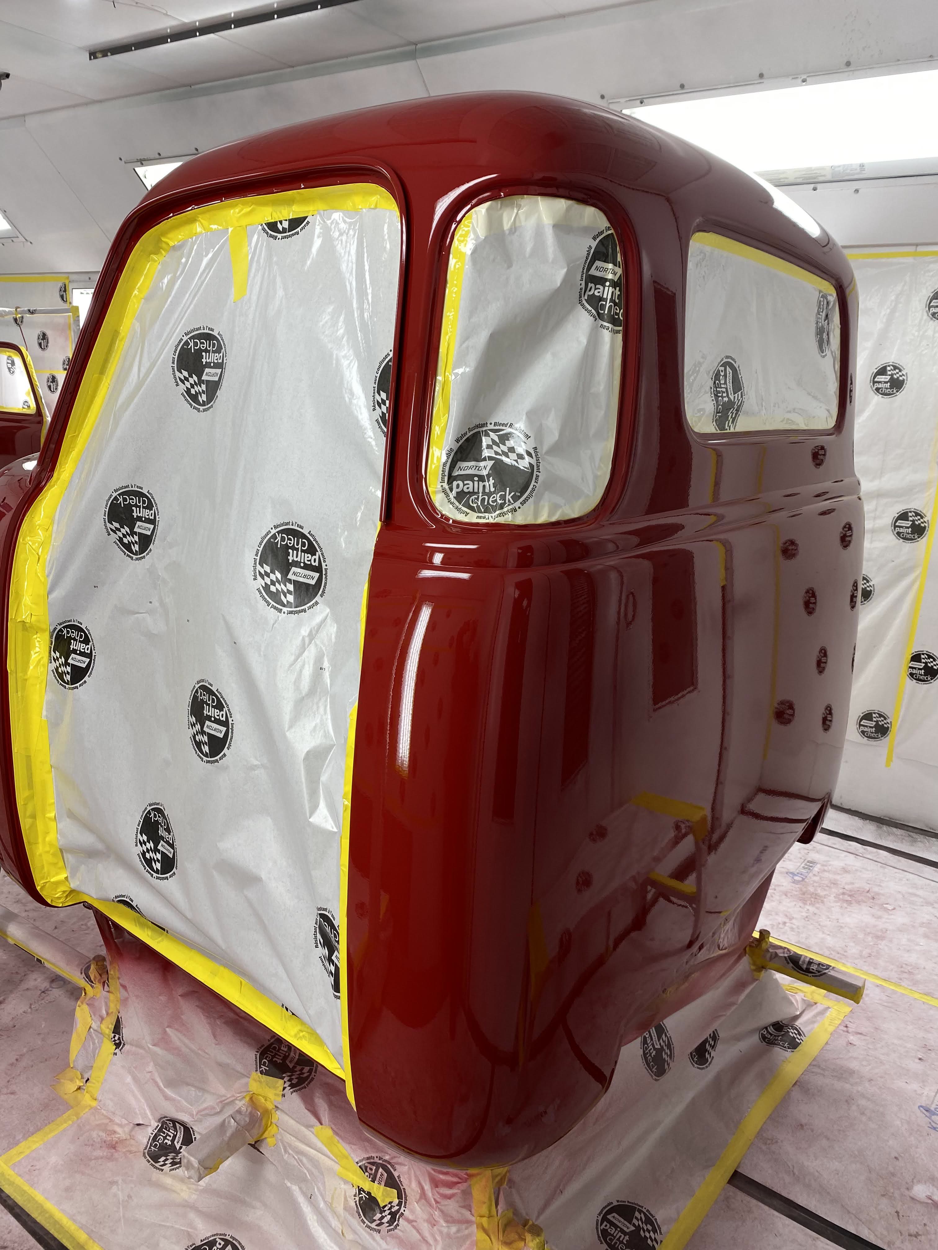 Cab masked off at the windows — glass openings papered so the sealer edges stay crisp.