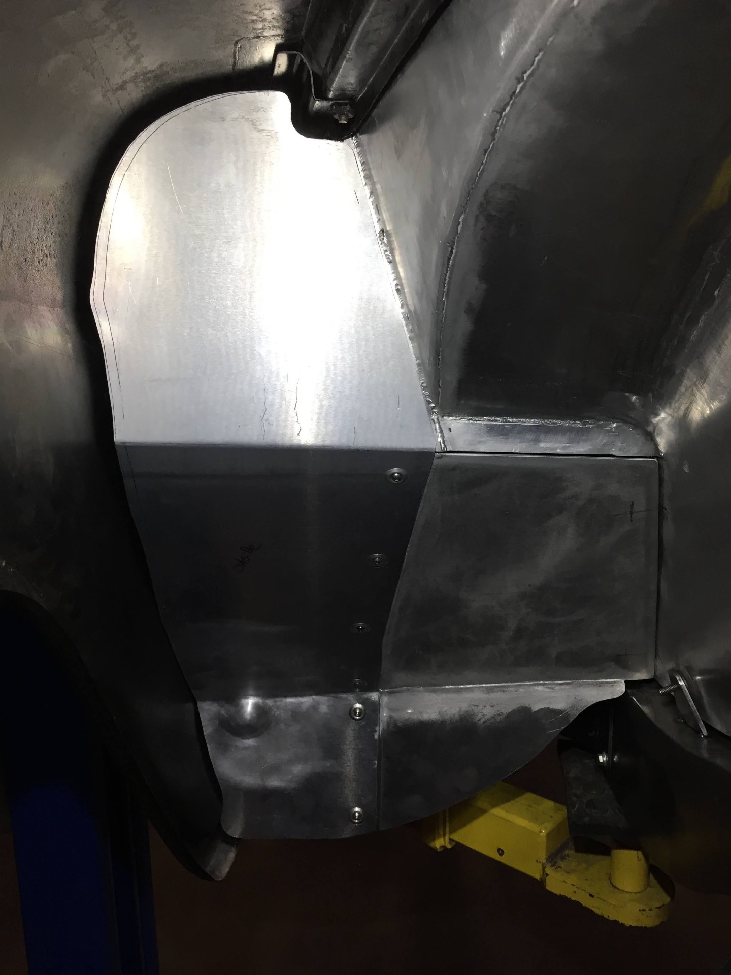 Hand-fabricated inner fender panel fitted into place.