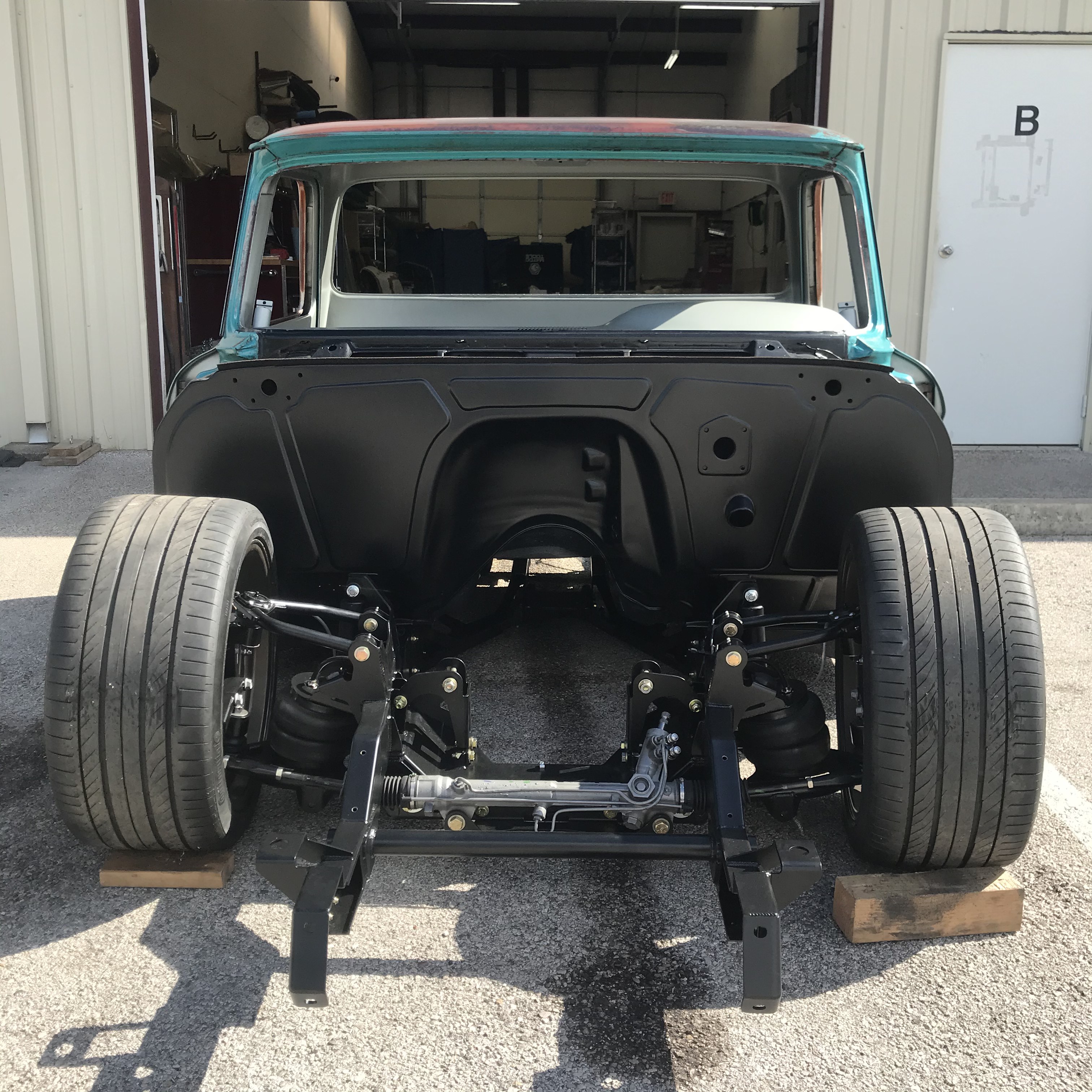 Cab set over the chassis during early fitment to establish stance and engine bay packaging.