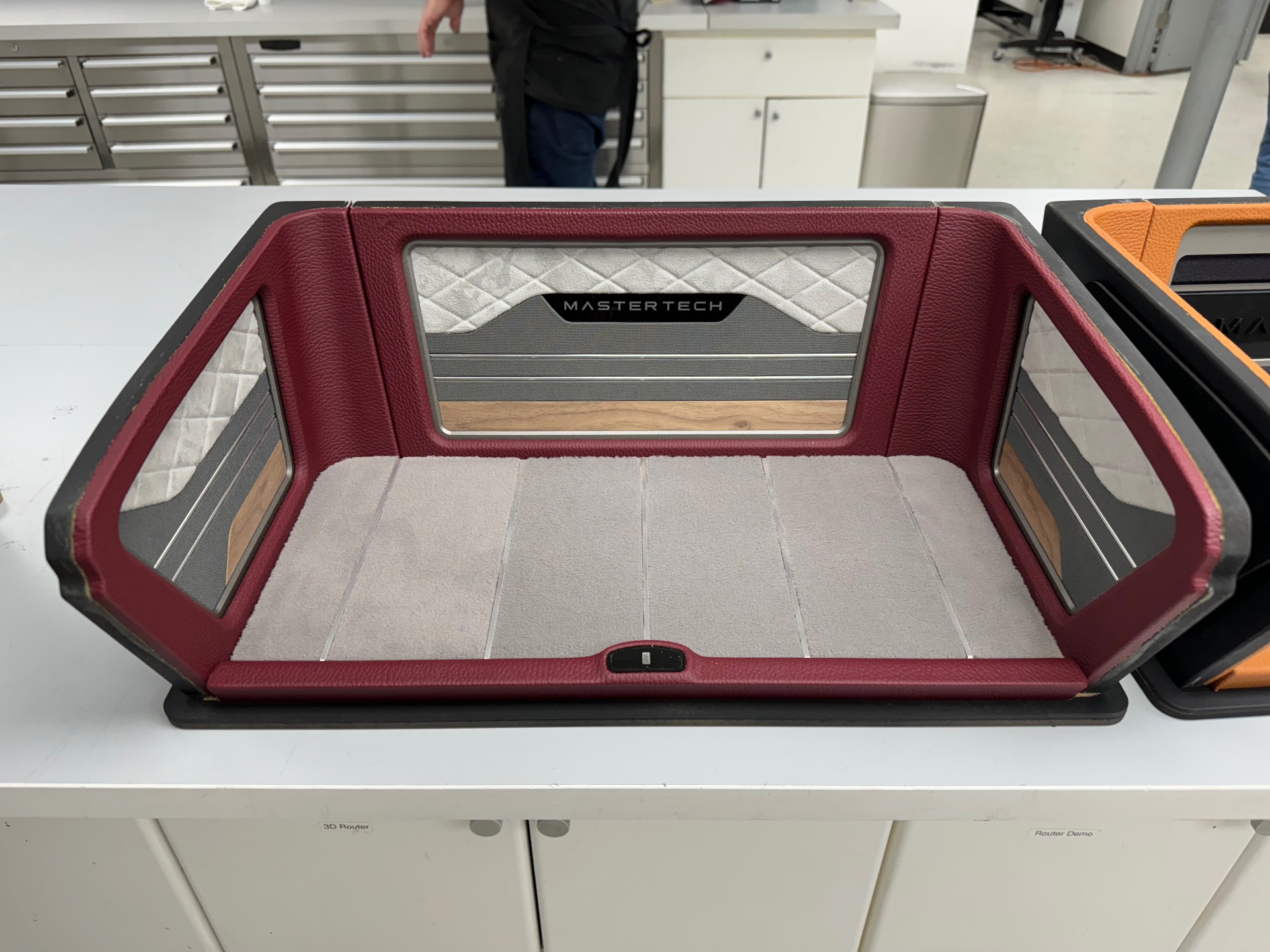 Finished mini trunk panel — leather, quilted suede, wood accent, and machined bezel.