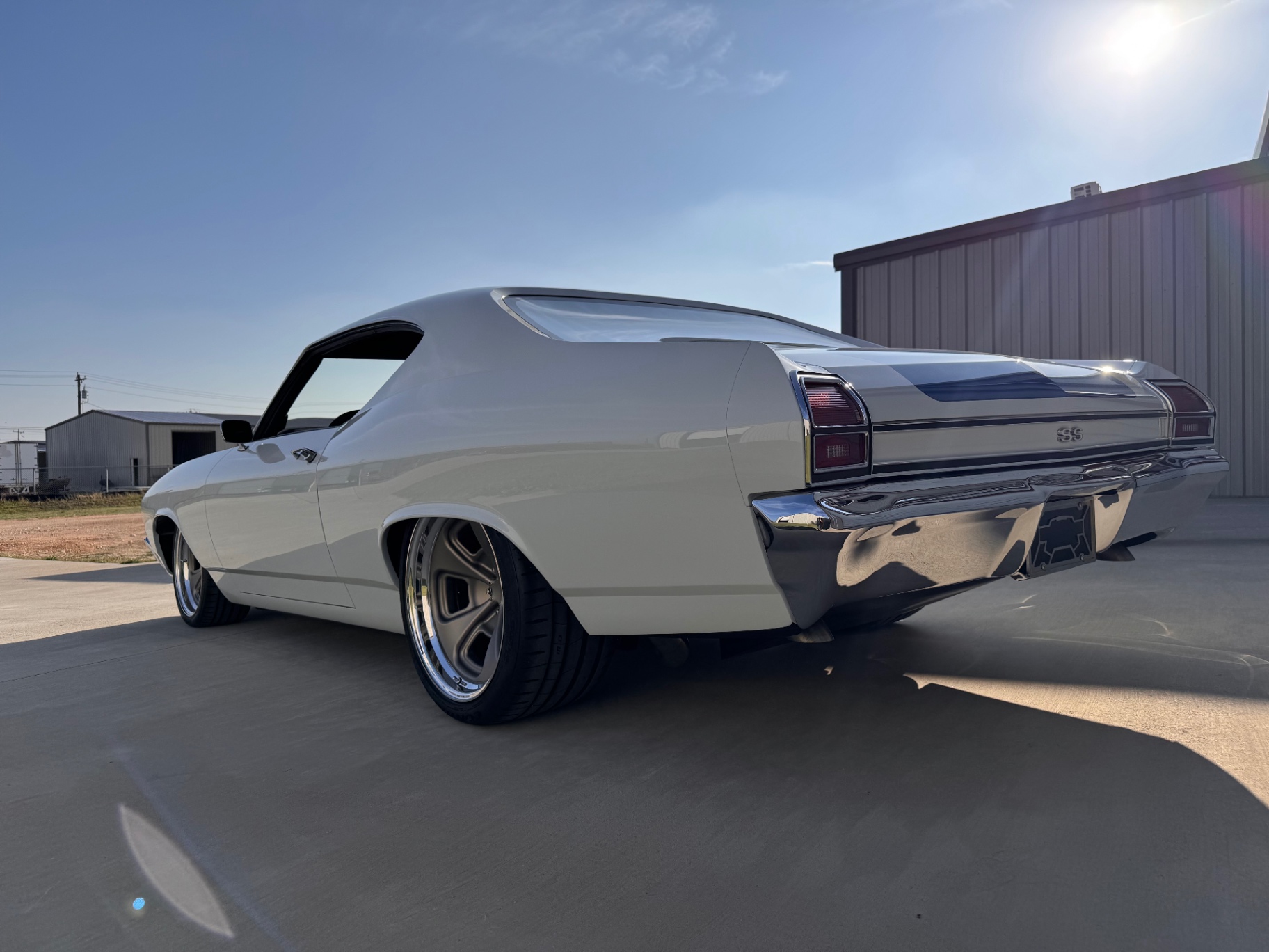 Driver-side rear three-quarter into the setting sun.