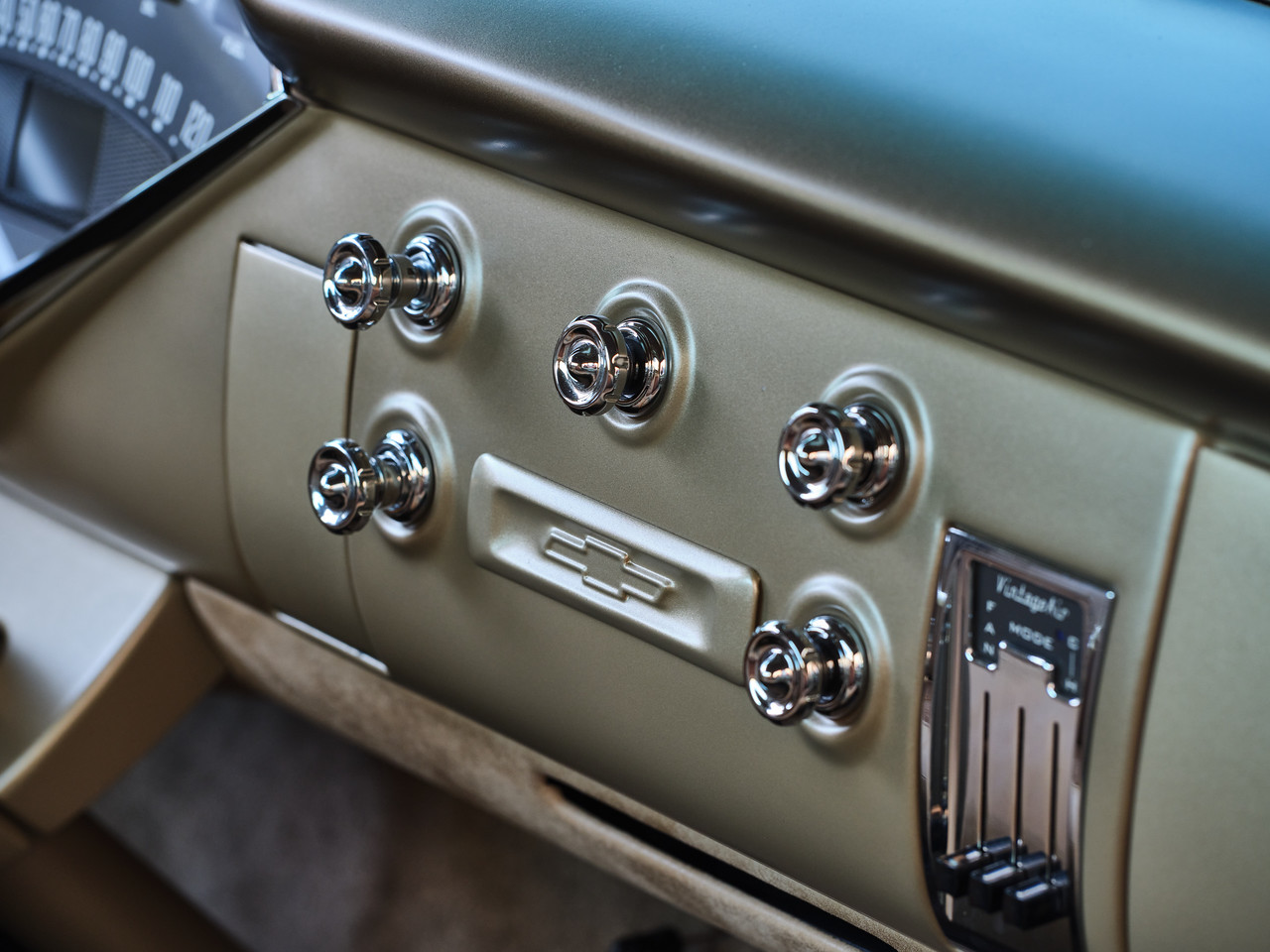 Dash detail — satin champagne metallic finish with chrome knobs from an old Packard and a Vintage Air control panel.
