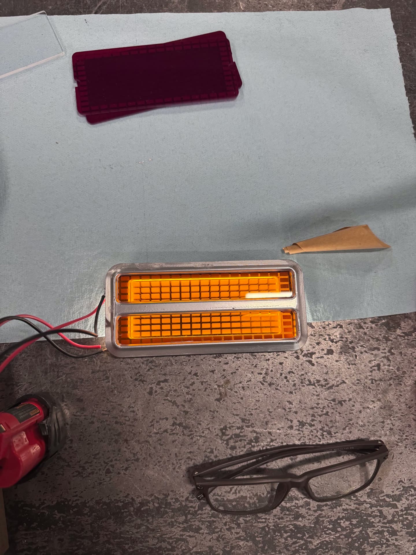 Amber output from the same engraved, side-lit lens.