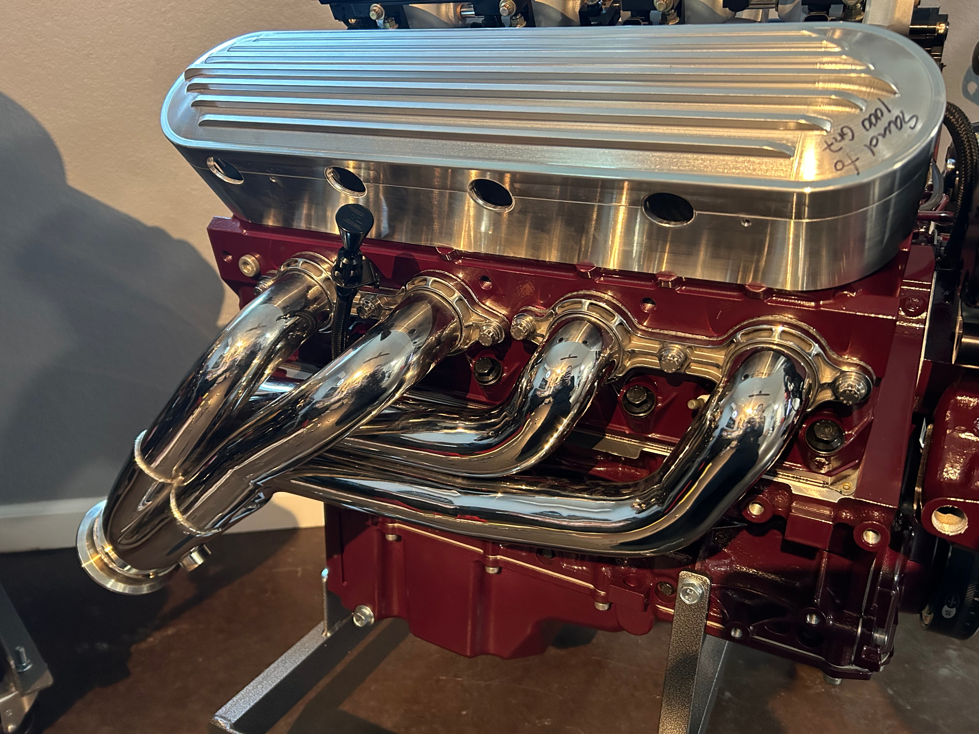 Polished stainless headers and finned valve cover detail.