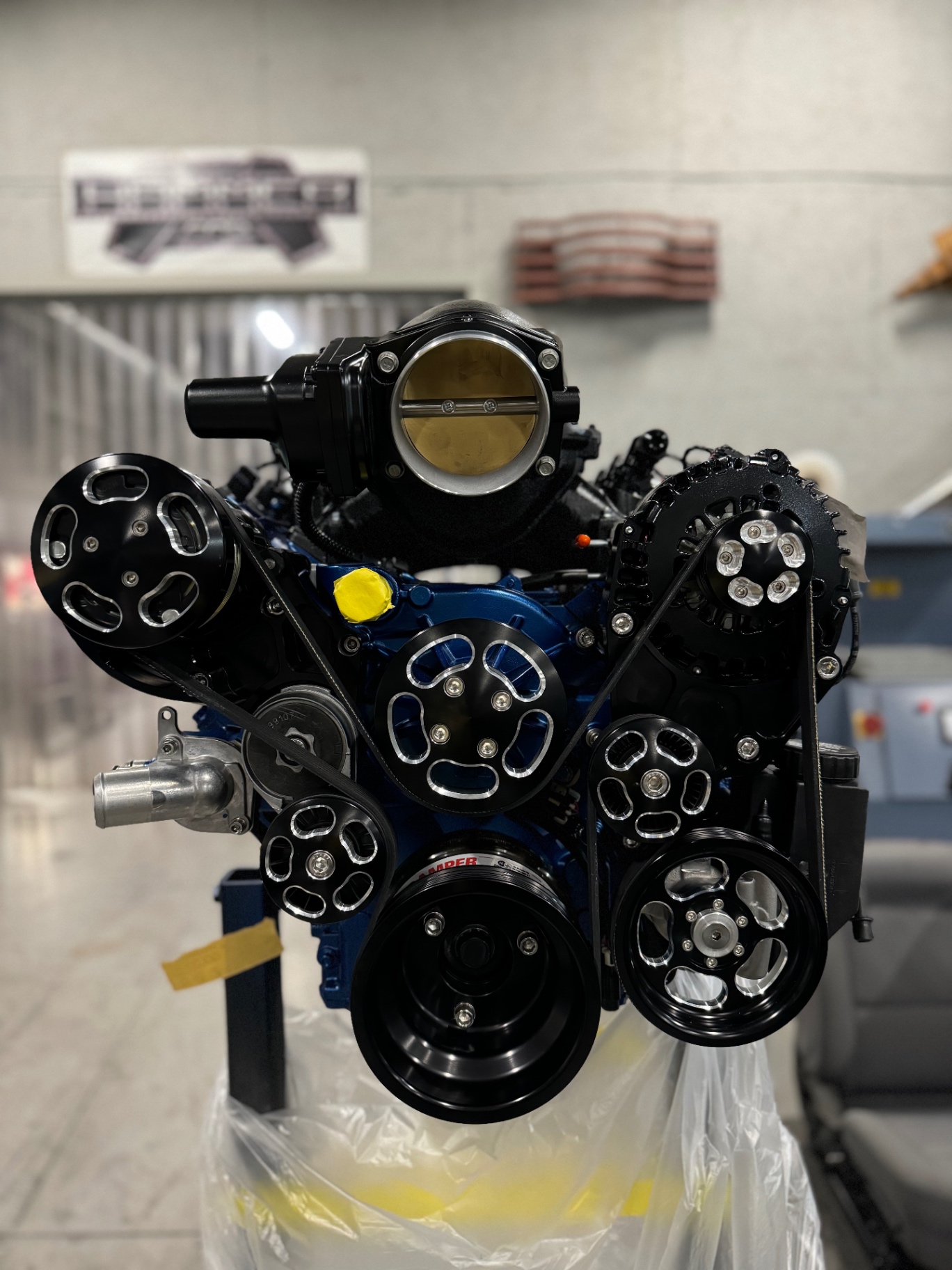 LS3 front dress — black serpentine accessory drive with billet pulleys over the blue block.