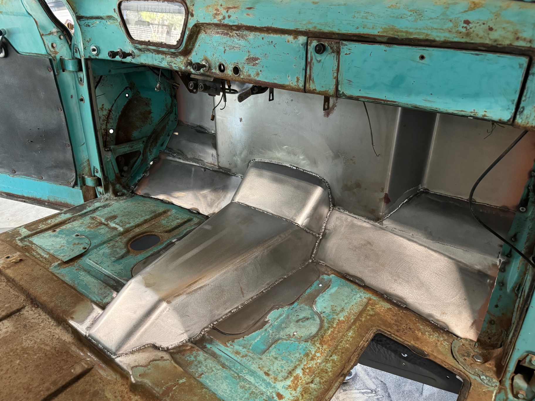 Wide view from the dash — the new tunnel tied into the original cab floor.