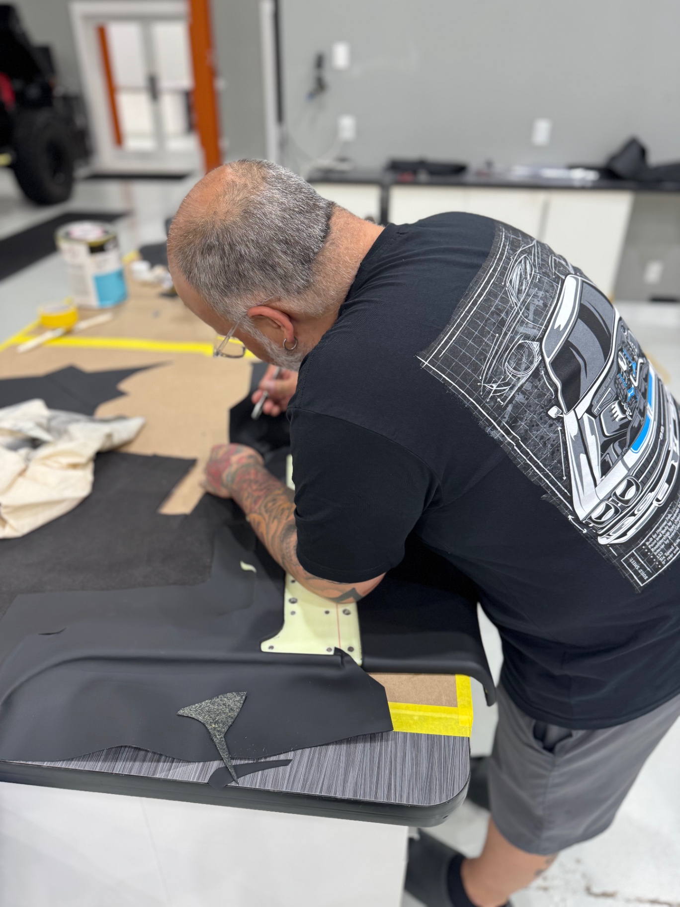 Avant Garde craftsman hand-cutting a door panel cover at the Palm City shop.