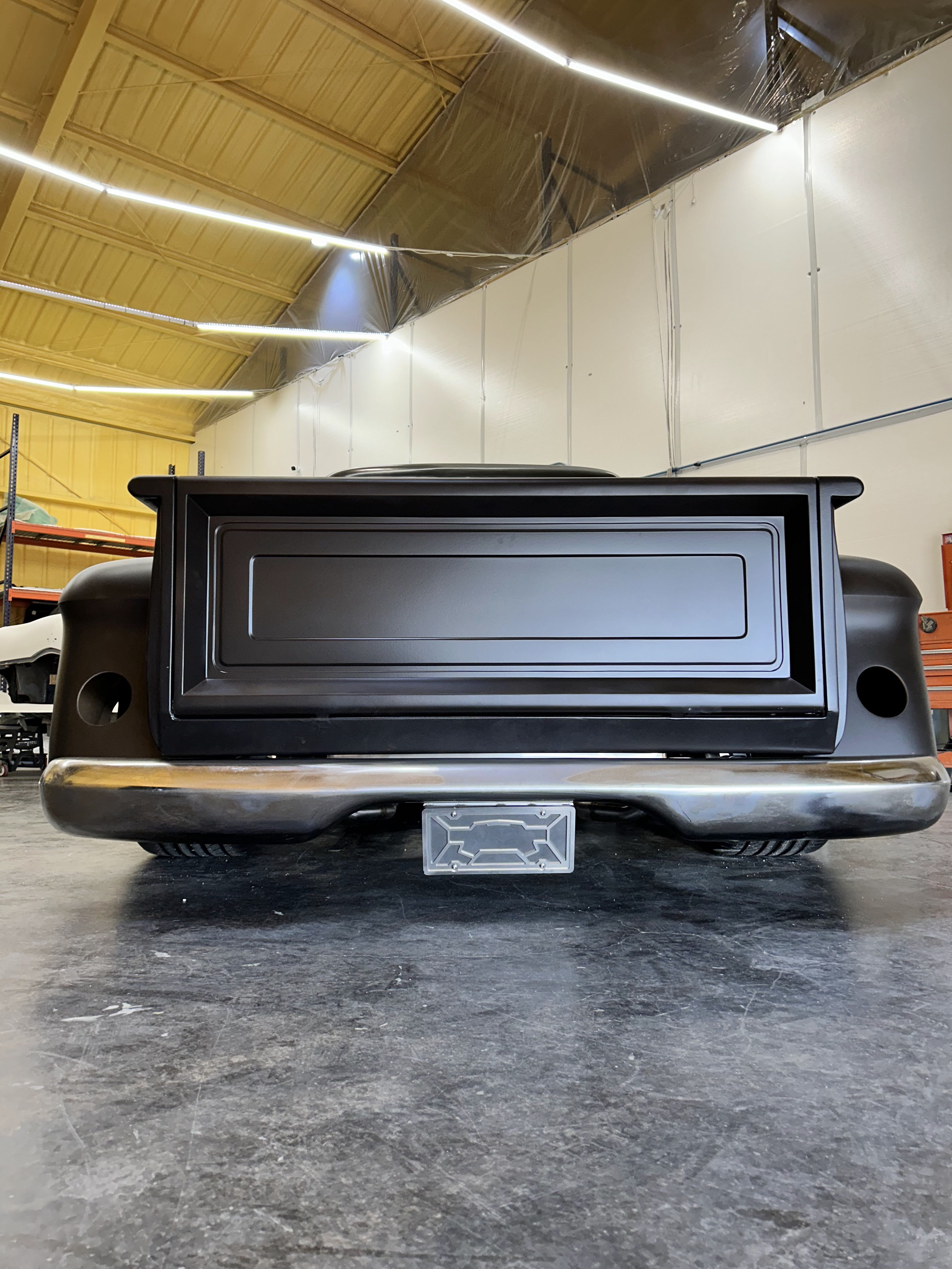Rear tailgate and roll-pan detail with license plate cavity.