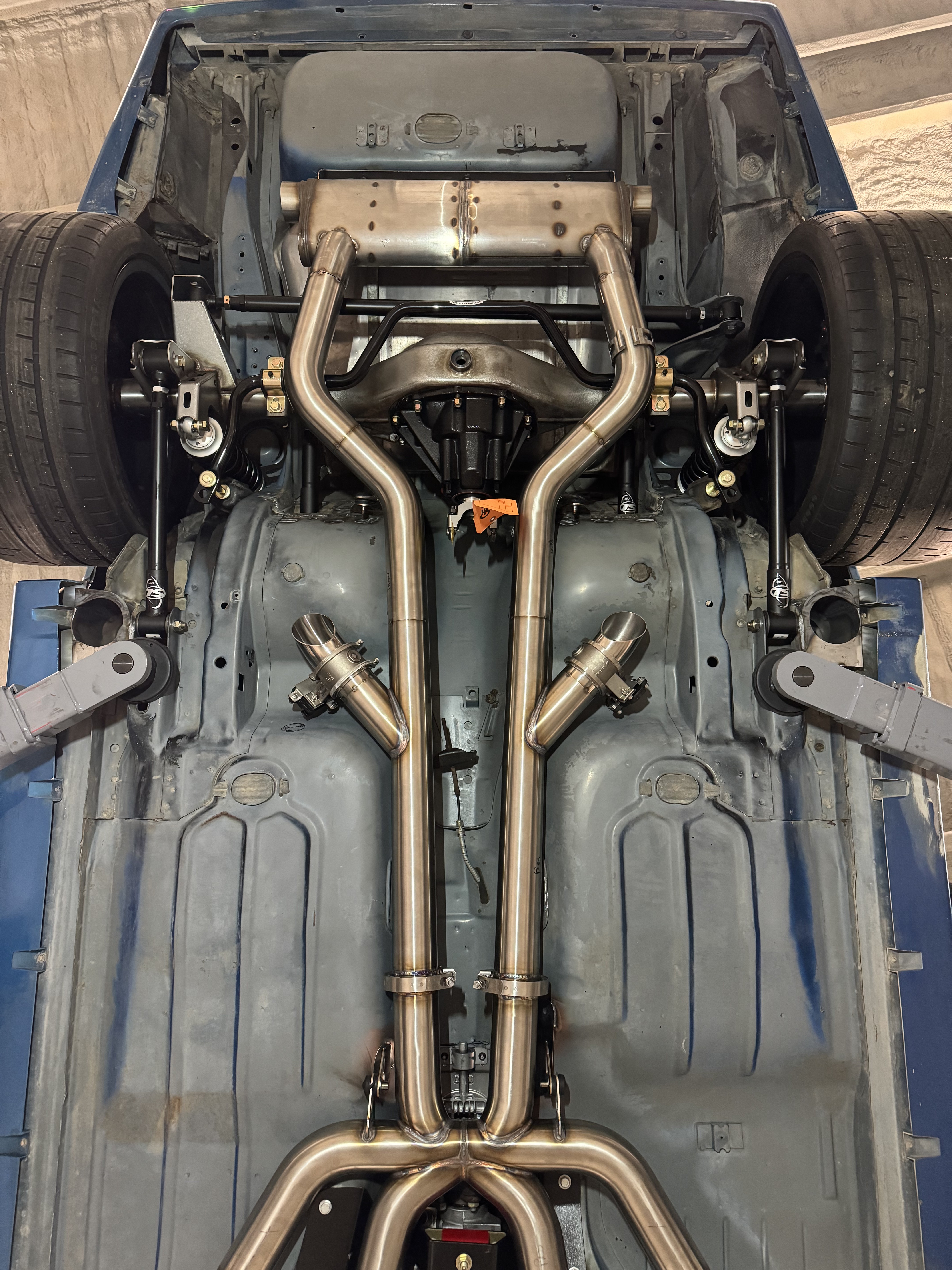 Full underbody layout showing the electric cutouts, dual 3-inch runs, and custom rear muffler.