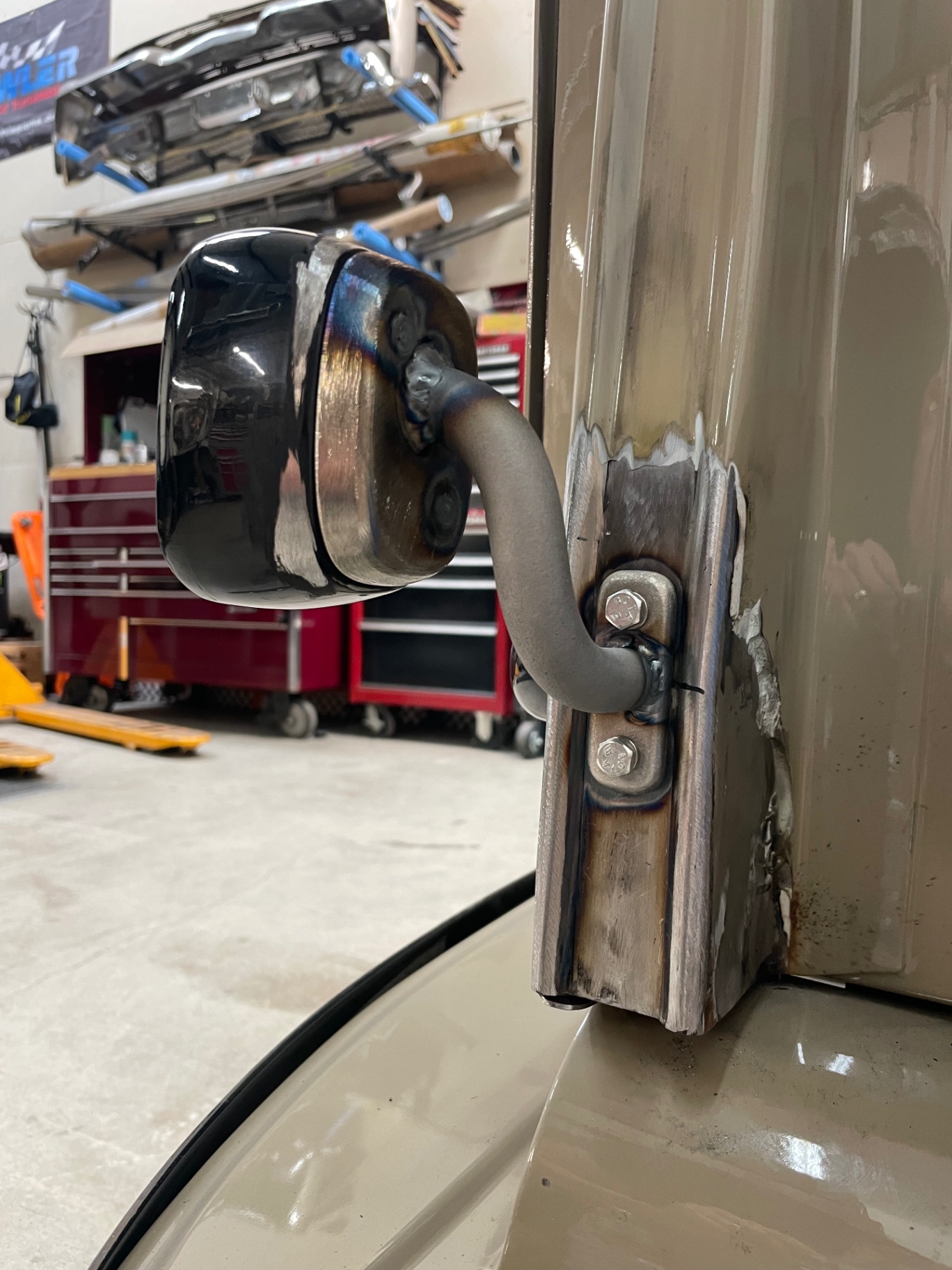 Tail light pedestal stem tacked to the bed — wires route through the center of the tube.