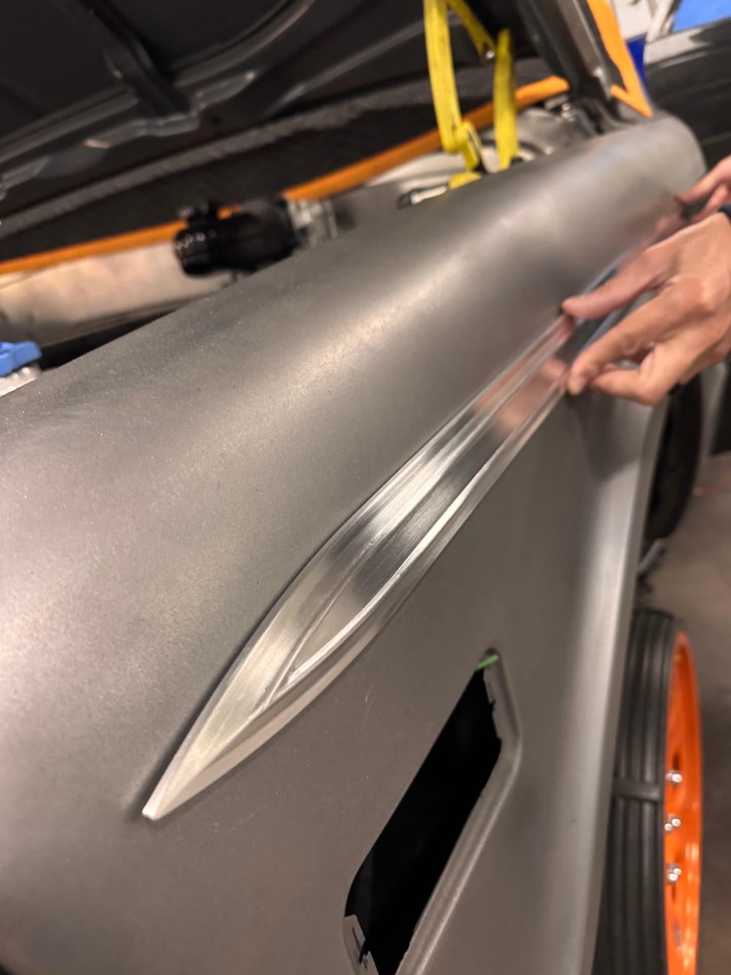 Billet spear held to the quarter to check the contour before mounting.