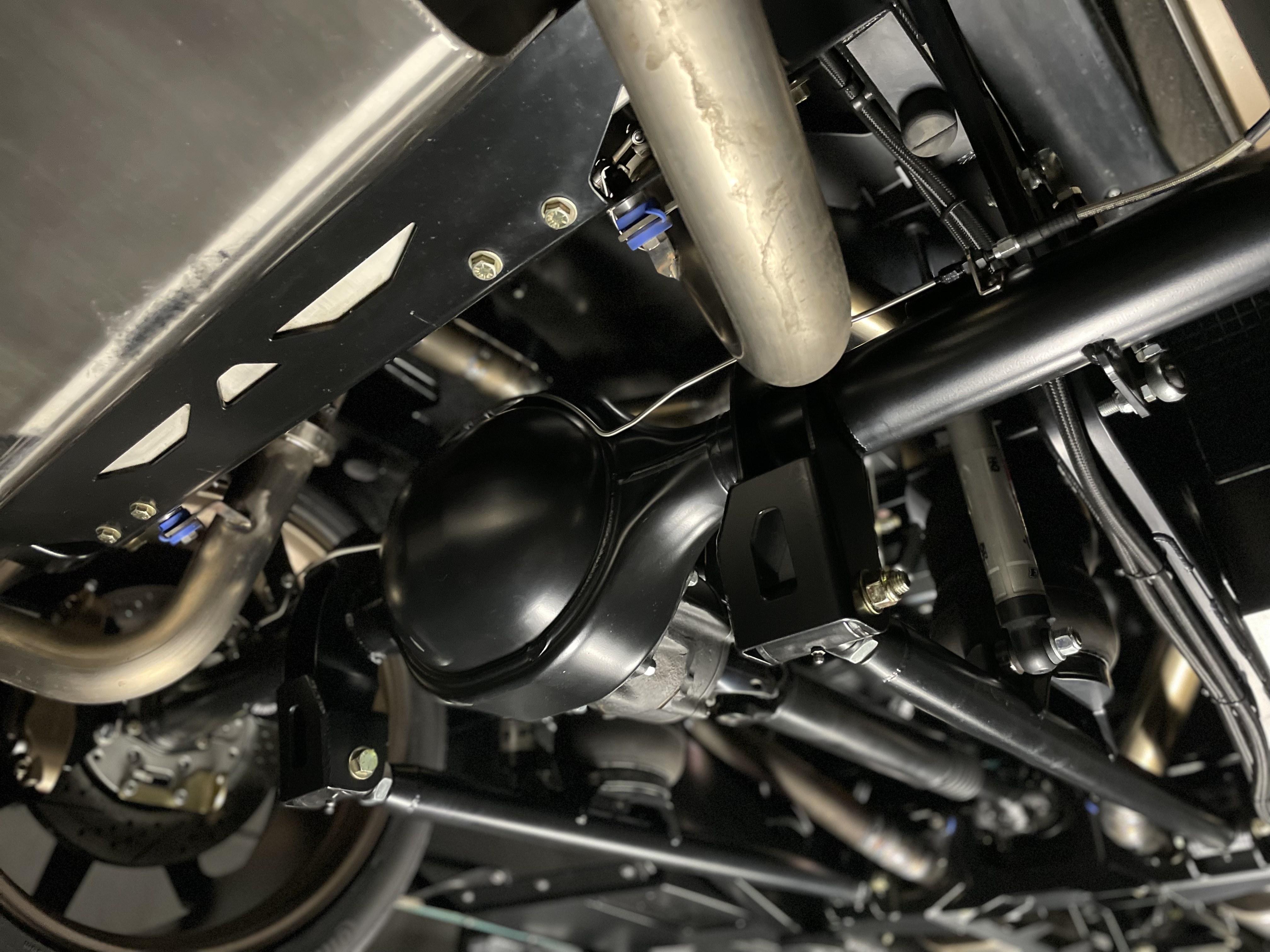 Finished chassis underside — Choppin Block extreme air-ride, satin black finish, and clean routing throughout the driveline.