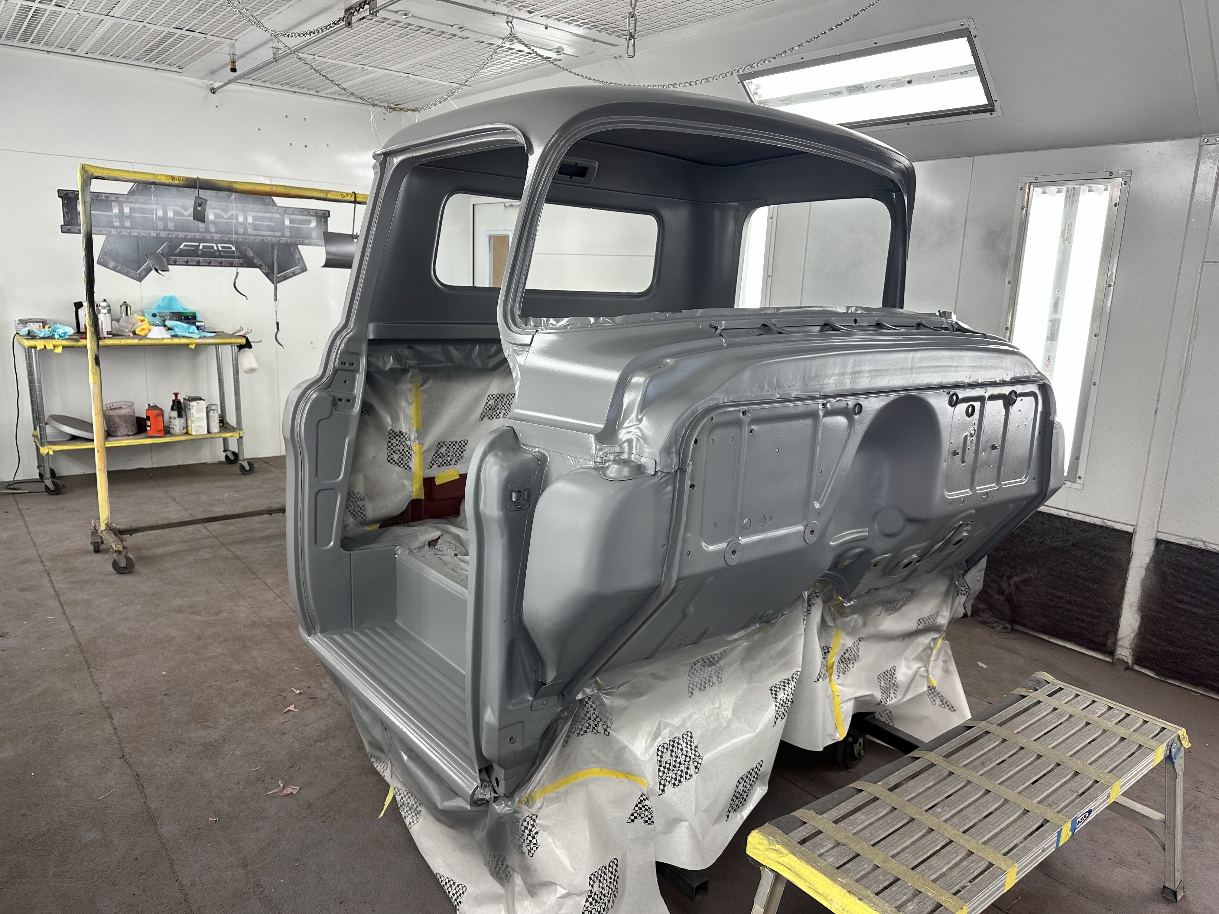 High build primer over epoxy — cab and front clip back in the booth.