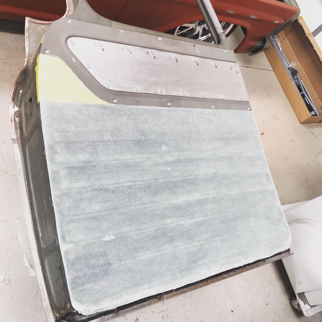 Fiberglass door panel attached with magnets; the upper insert base is aluminum and gets covered in vintage fabric.
