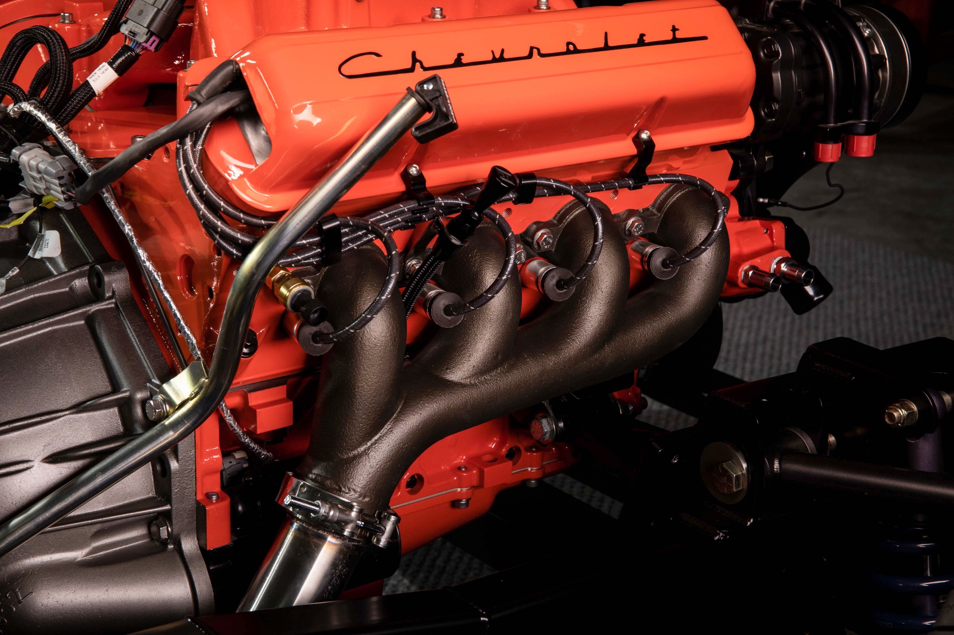Cast iron exhaust manifold sprayed in-house with bronze Zybar high-temp polymer coating, TIG-welded V-band flange at the collector for a leak-free joint.