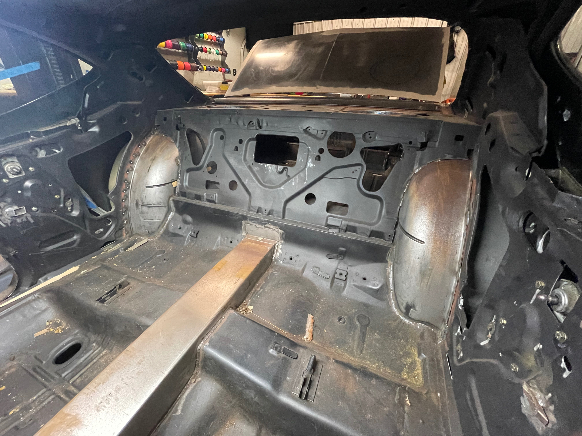 Interior stripped — firewall and floor prepped for tunnel modifications.