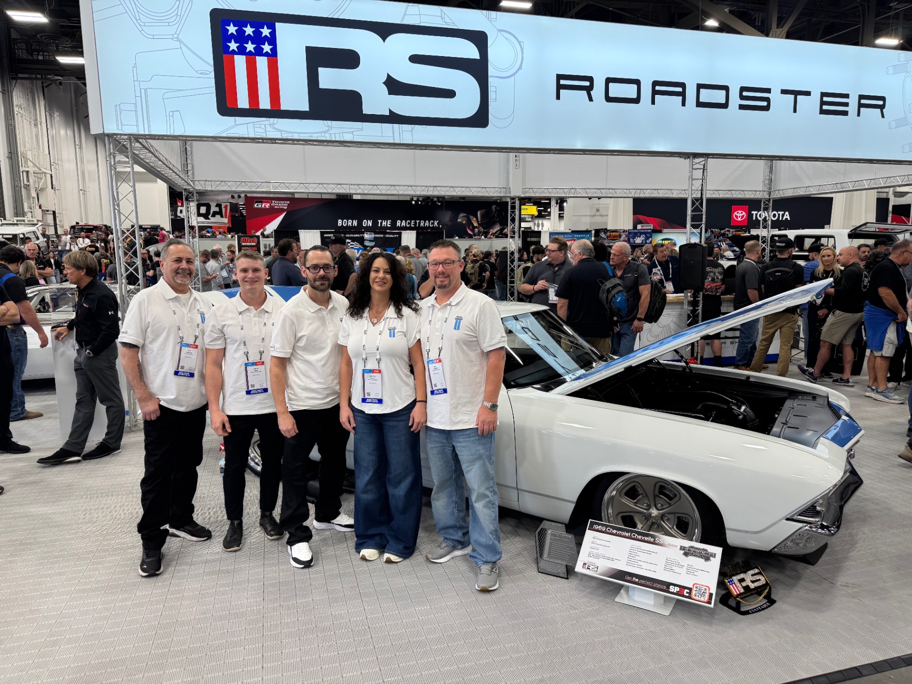 The Hammer Fab crew alongside the finished car in the Roadster Shop booth.