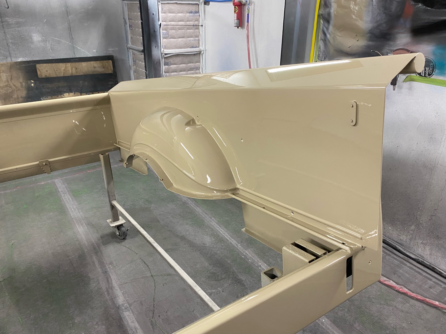 Passenger-side bed panel — matching finish, reflections telling the story.