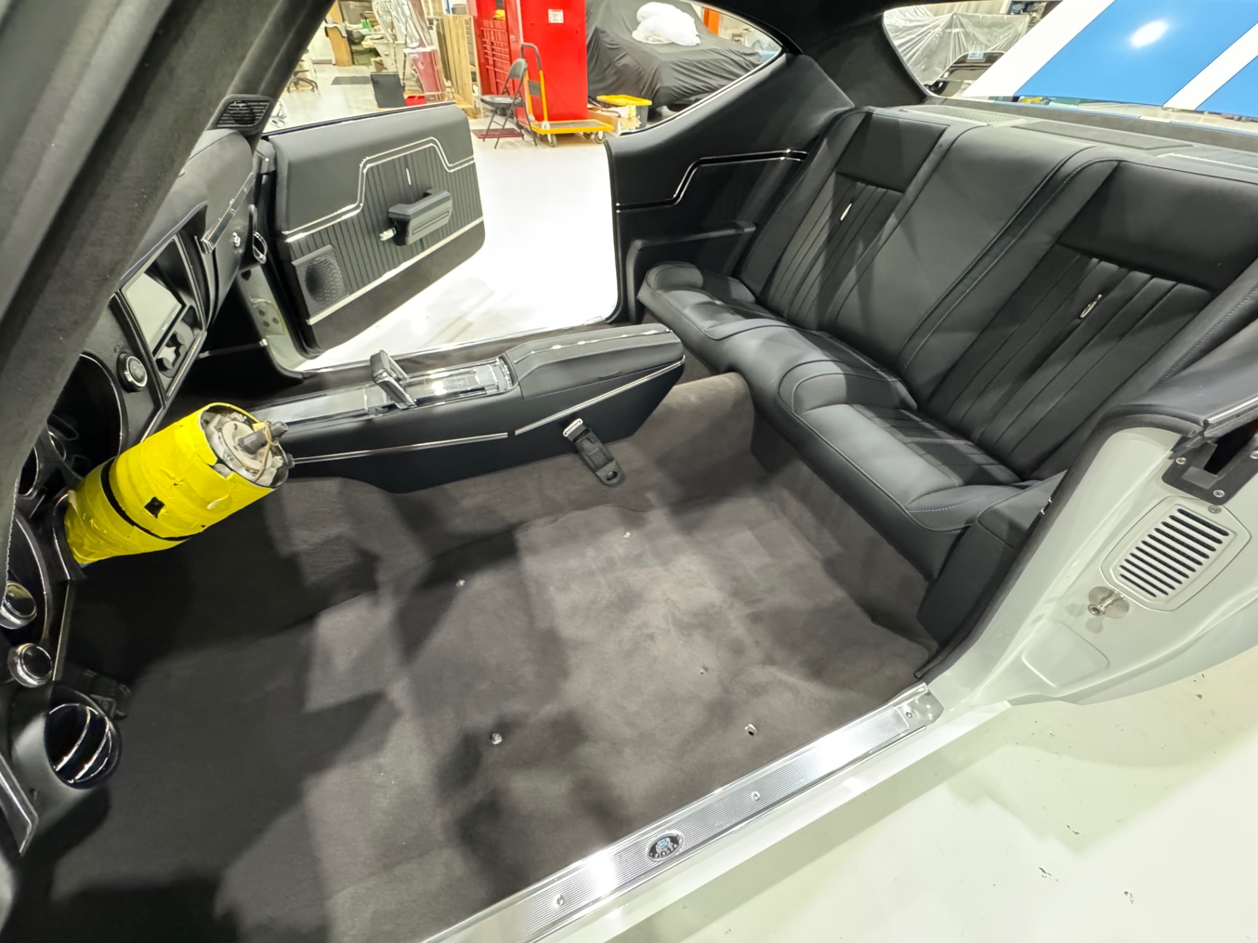 Passenger side installed — console, rear seat, carpet, and door panel in place.
