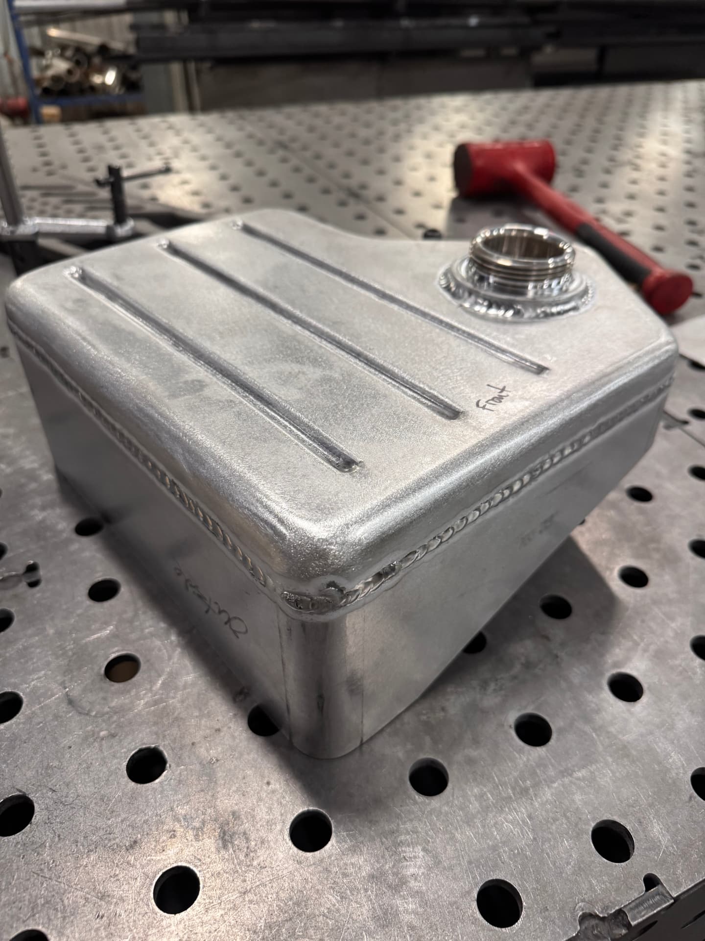 Hand-made aluminum coolant expansion tank, welded and beaded in house.