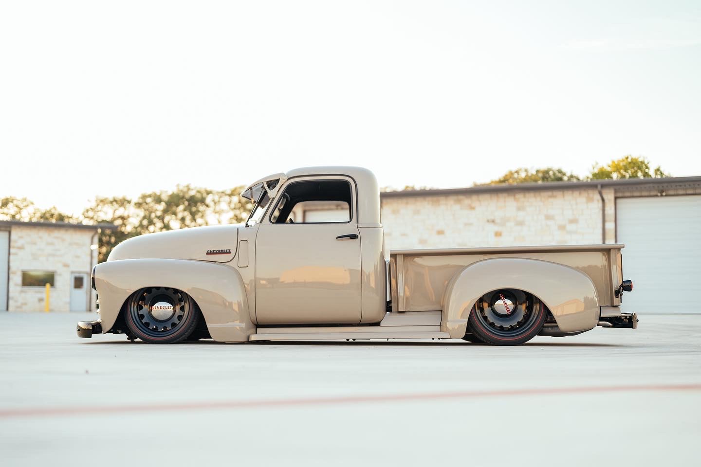 Side profile — air dumped, 18/20 Detroit Steel Wheels on Diamond Back redlines.