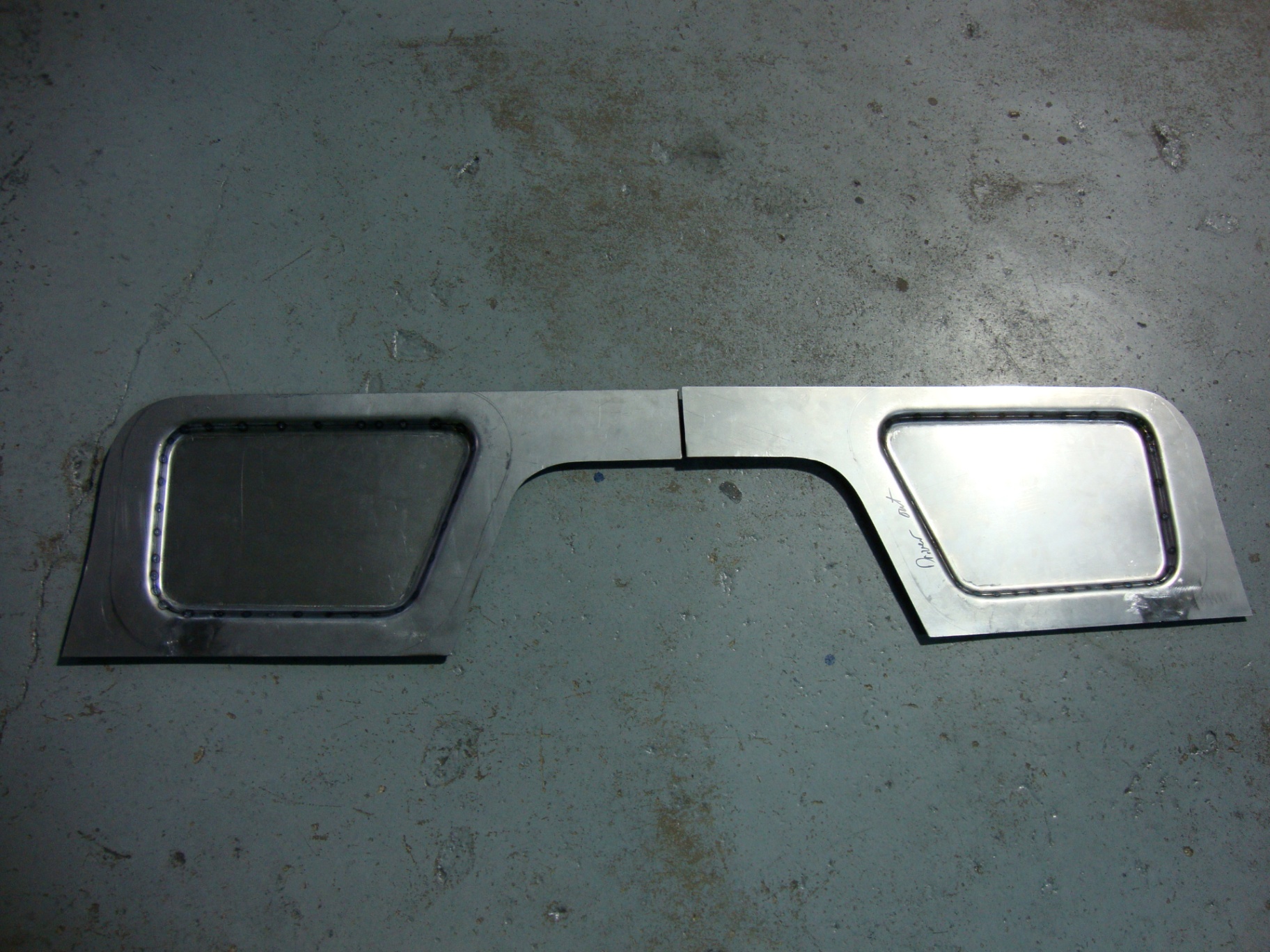 Hand-fabricated custom 14 ga steel firewall with recessed access windows, ready for fit-up.