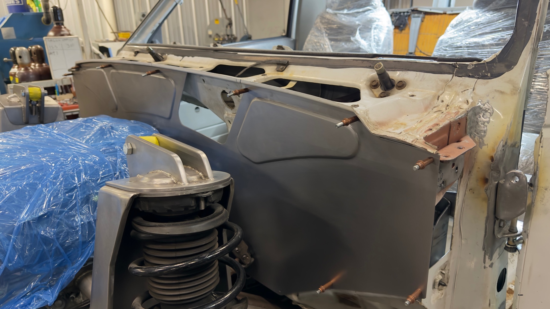 Firewall panel test-fit with clecos before final weld.
