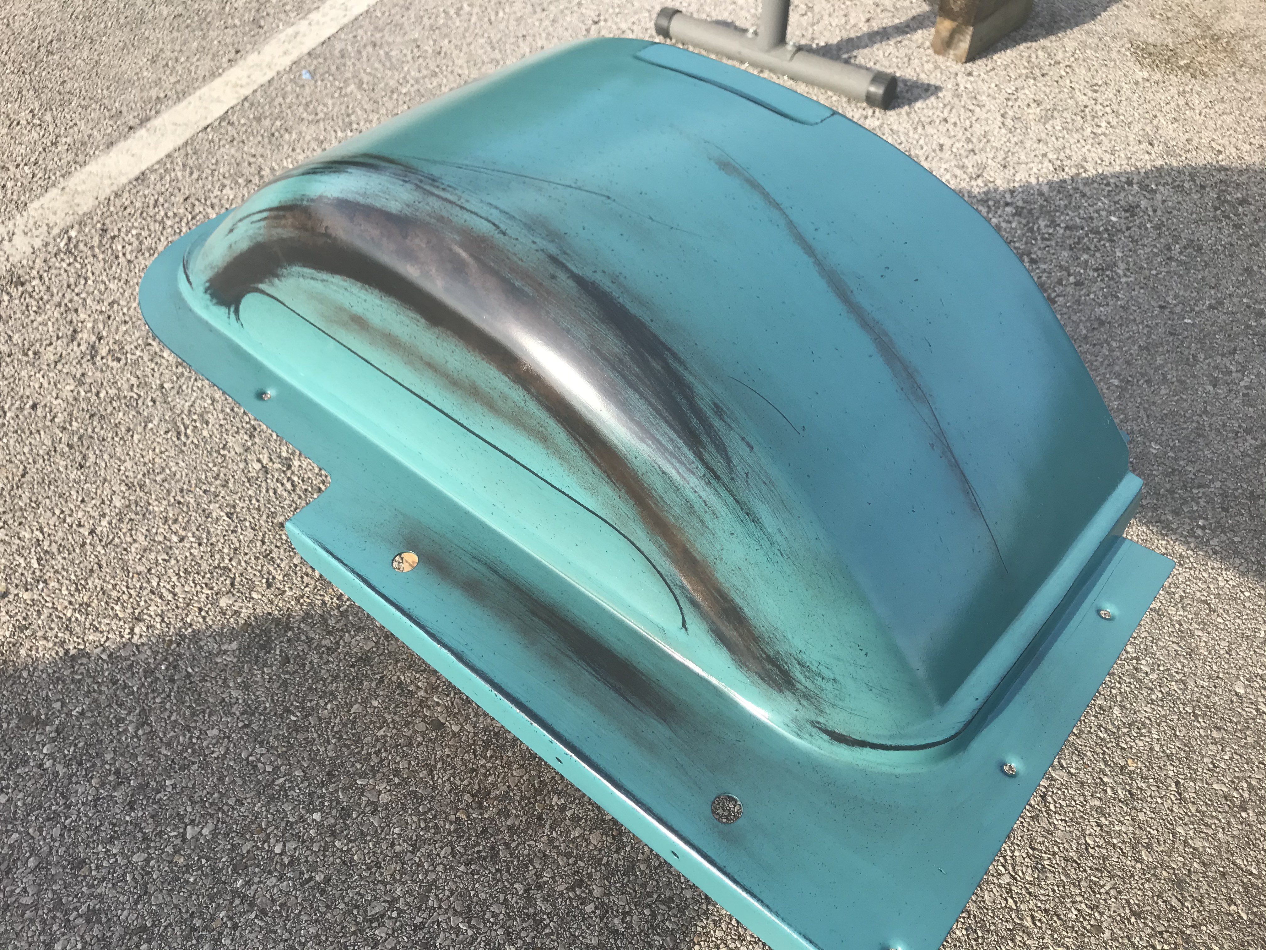 Refinished inner front fender with fauxtina blending — matching sun fade and worn edges before the panel goes on the truck.