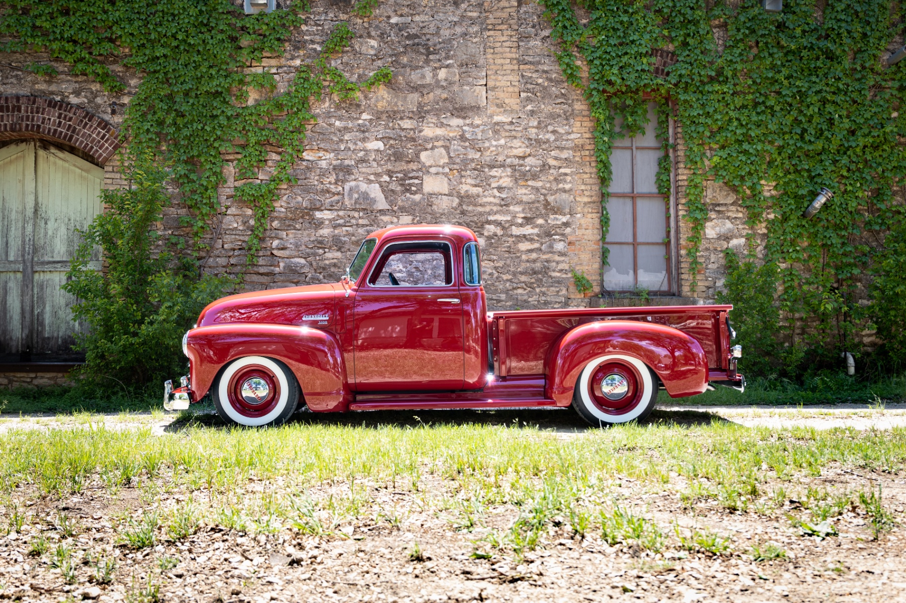 Driver-side profile — five-window cab and long-bed proportions reading straight down the body line.