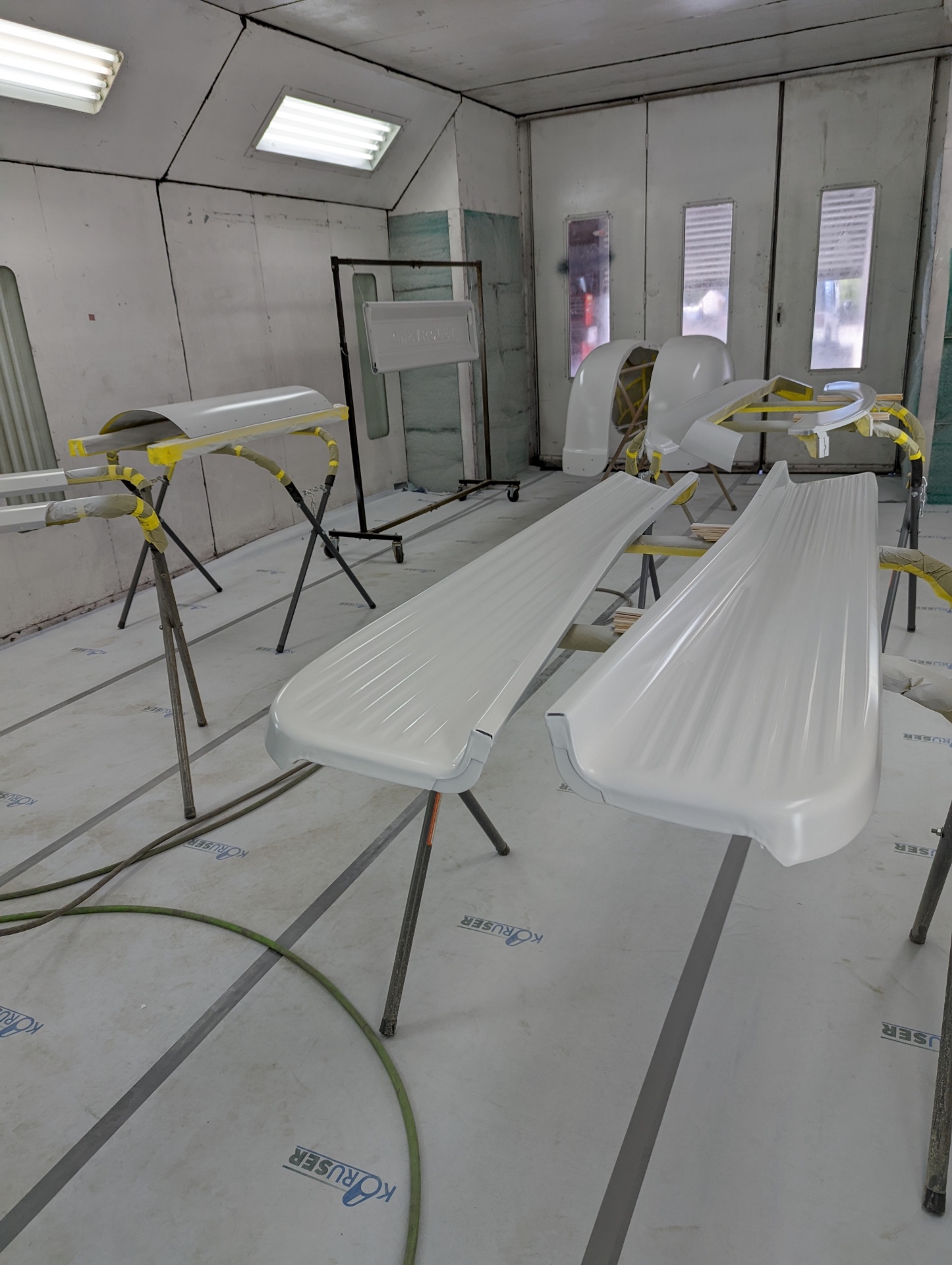 First base coat going on — white sealer laid down on the running boards.