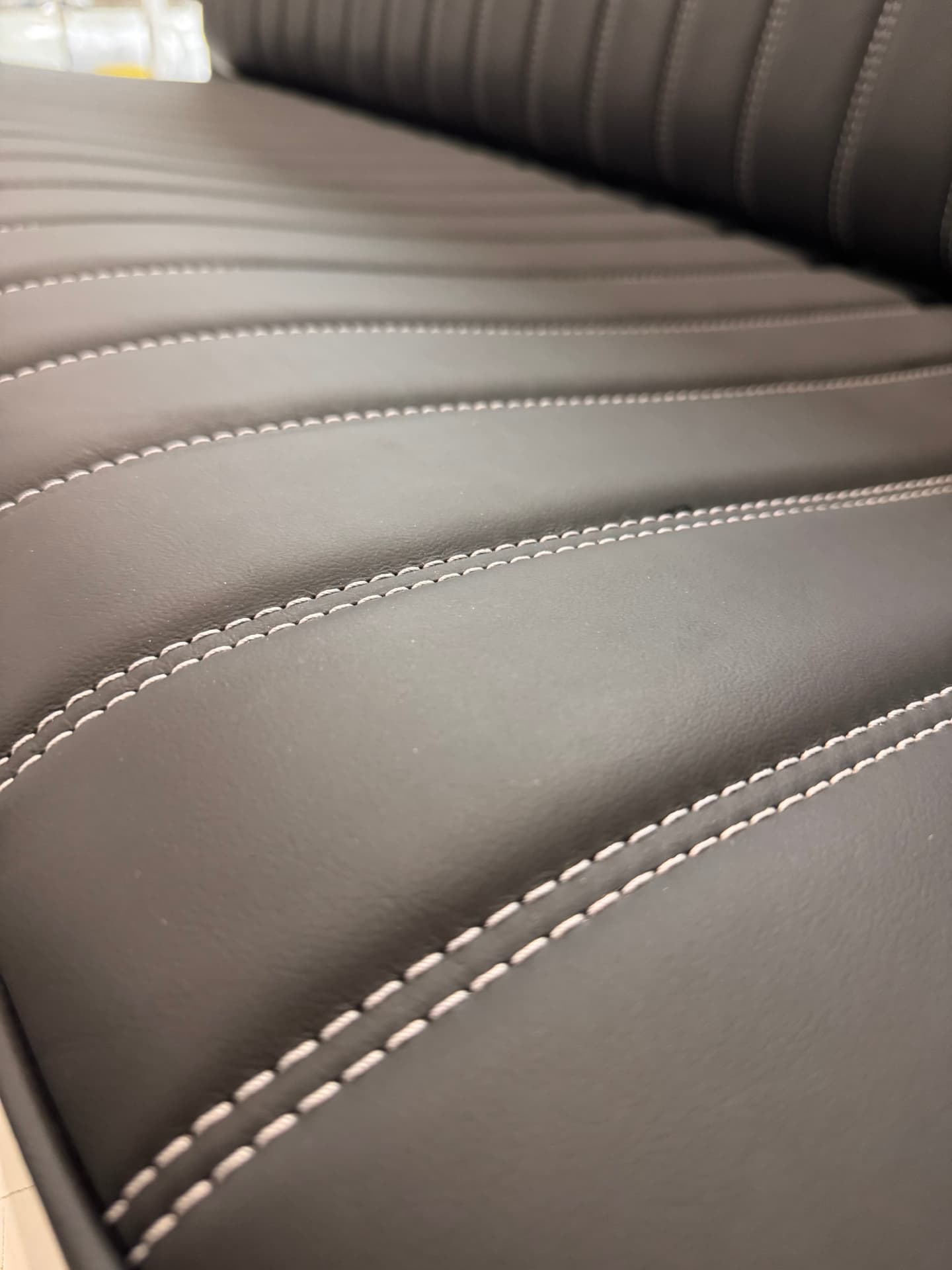 Double-needle contrast stitching, tight and consistent throughout.