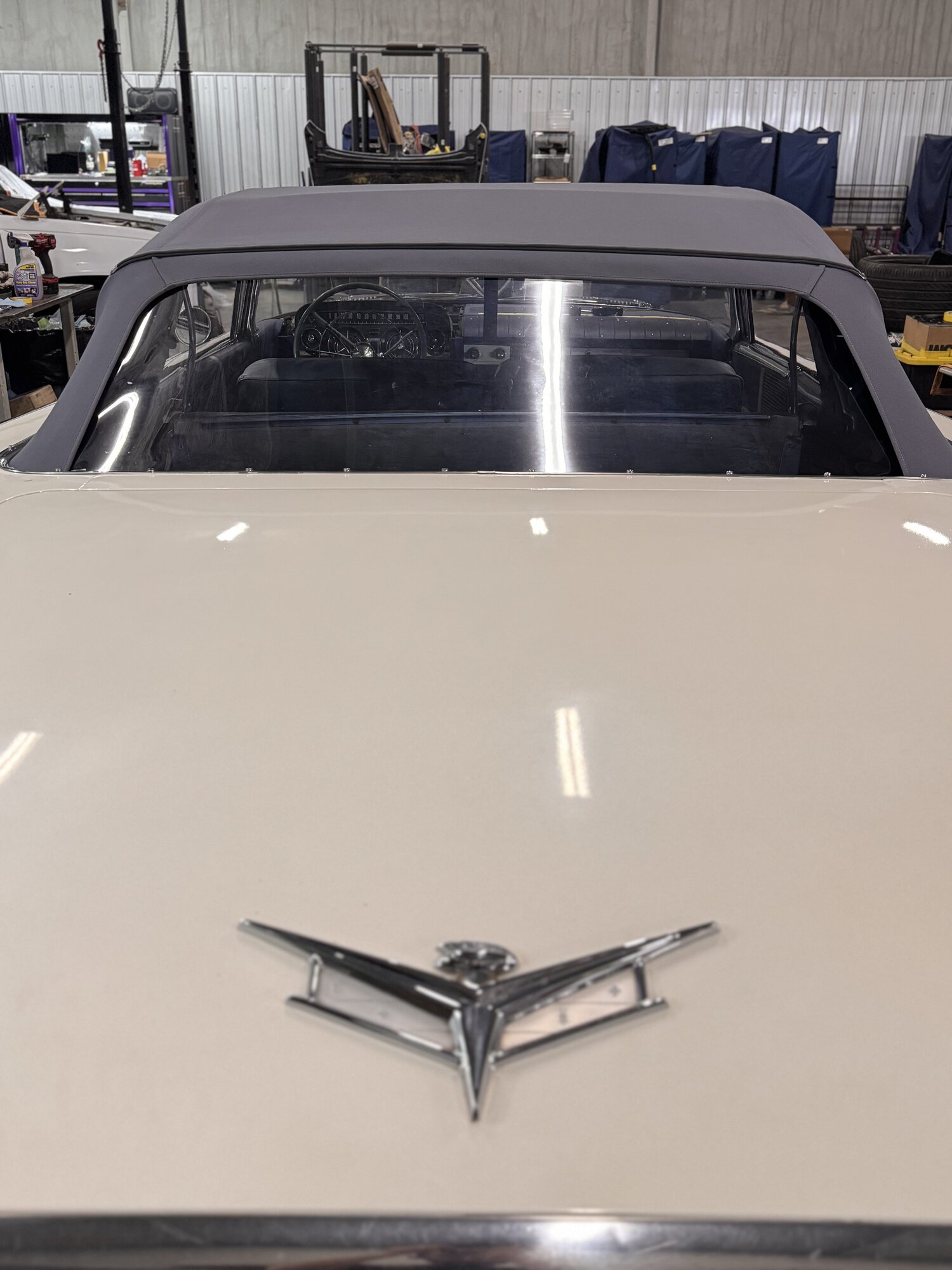 Straight-on rear view over the deck lid and Buick V emblem, rear glass sitting clean in the frame